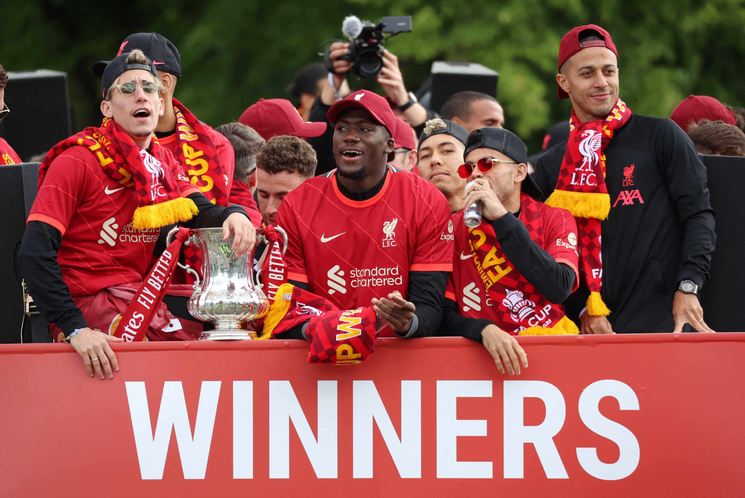Soccer Football - Liverpool victory parade - Liverpool, Britain - May 29, 2022 Liverpool's Ibrahima Konate, Luis Diaz, Thiago Alcantara and Kostas Tsimikas celebrate with the FA Cup trophy during the bus parade REUTERS
