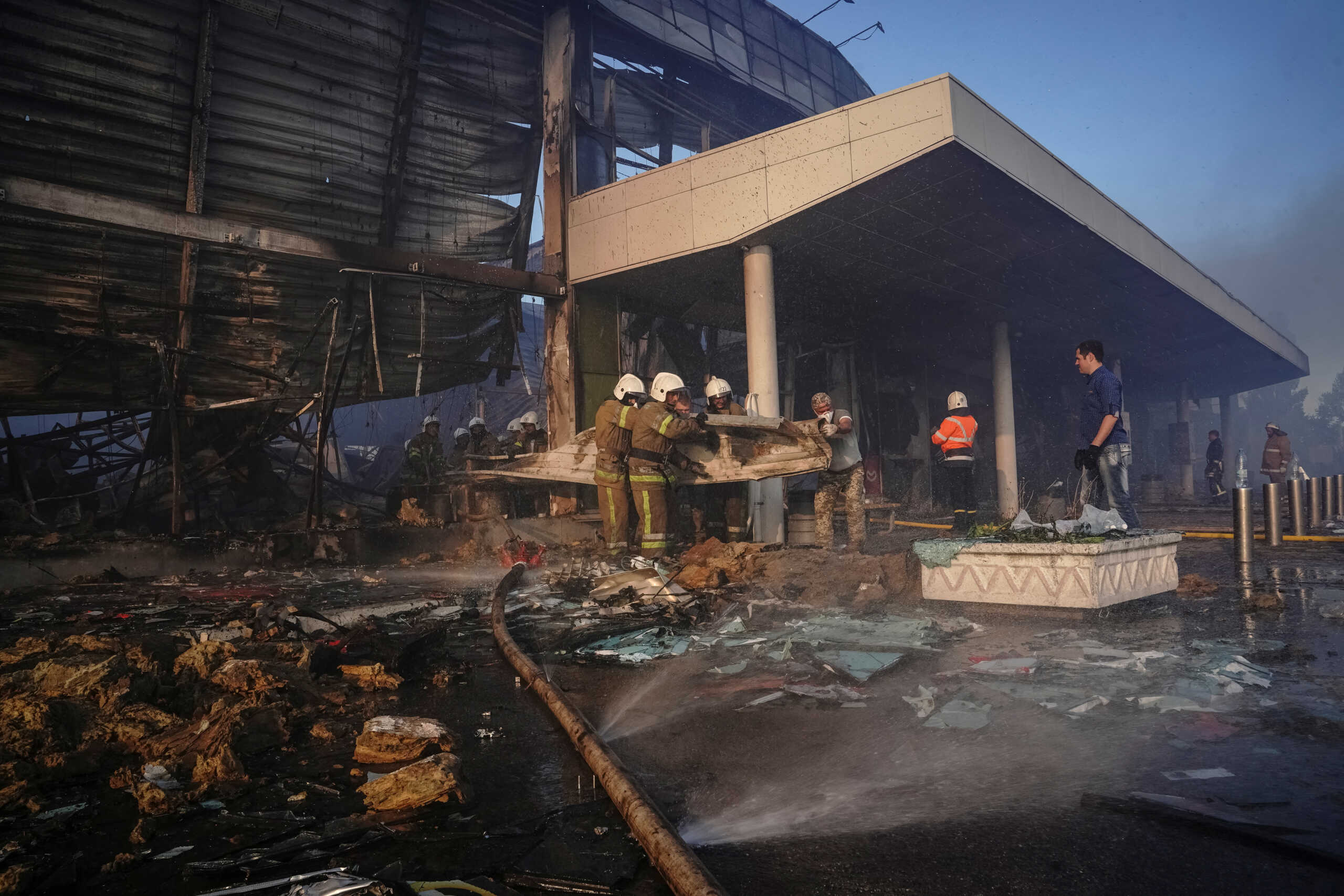 Rescuers work at a site of a shopping mall hit by a Russian missile strike, as Russia's attack on Ukraine continues, in Kremenchuk, in Poltava region, Ukraine June 27, 2022. Picture taken June 27, 2022. REUTERS