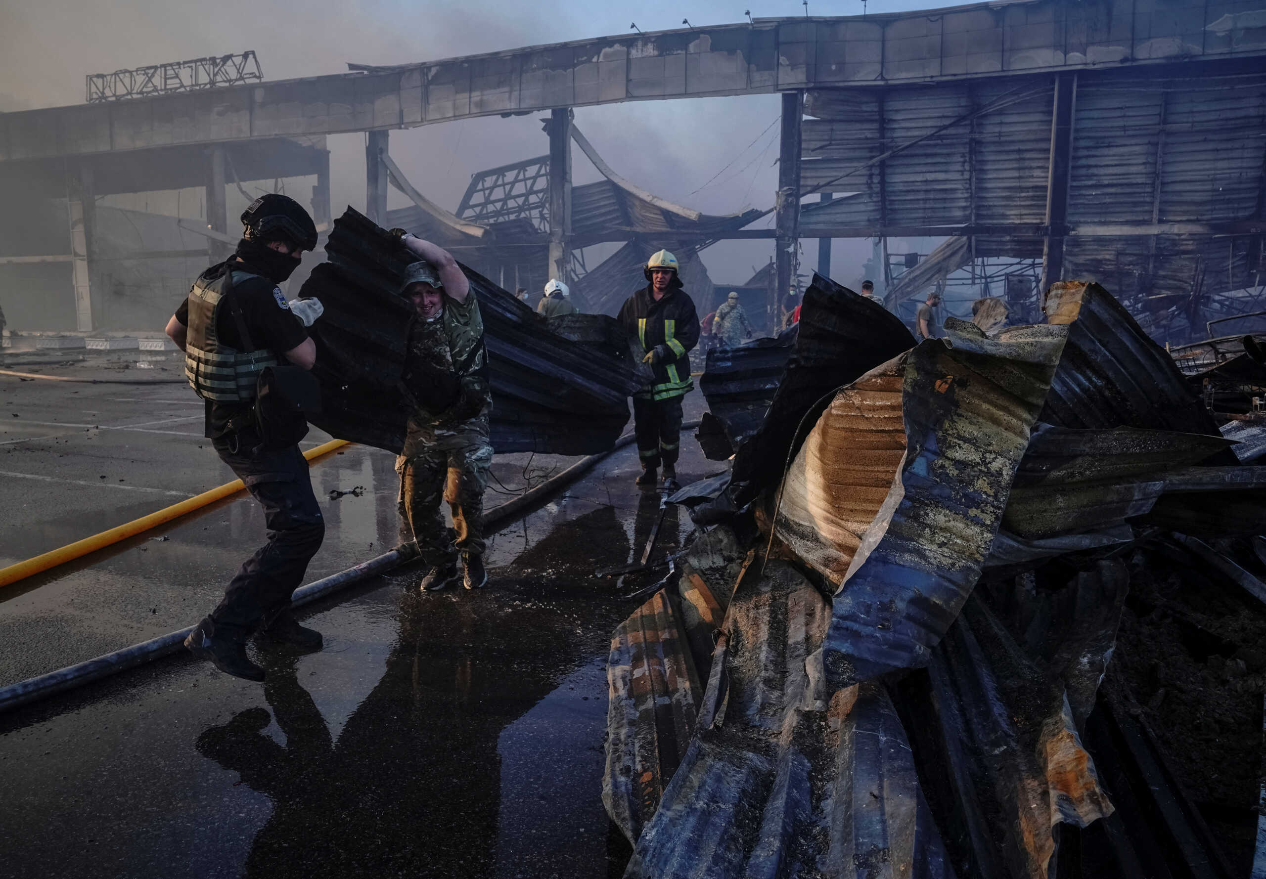Rescuers and service members work at a site of a shopping mall hit by a Russian missile strike, as Russia's attack on Ukraine continues, in Kremenchuk, in Poltava region, Ukraine June 27, 2022. Picture taken June 27, 2022. REUTERS