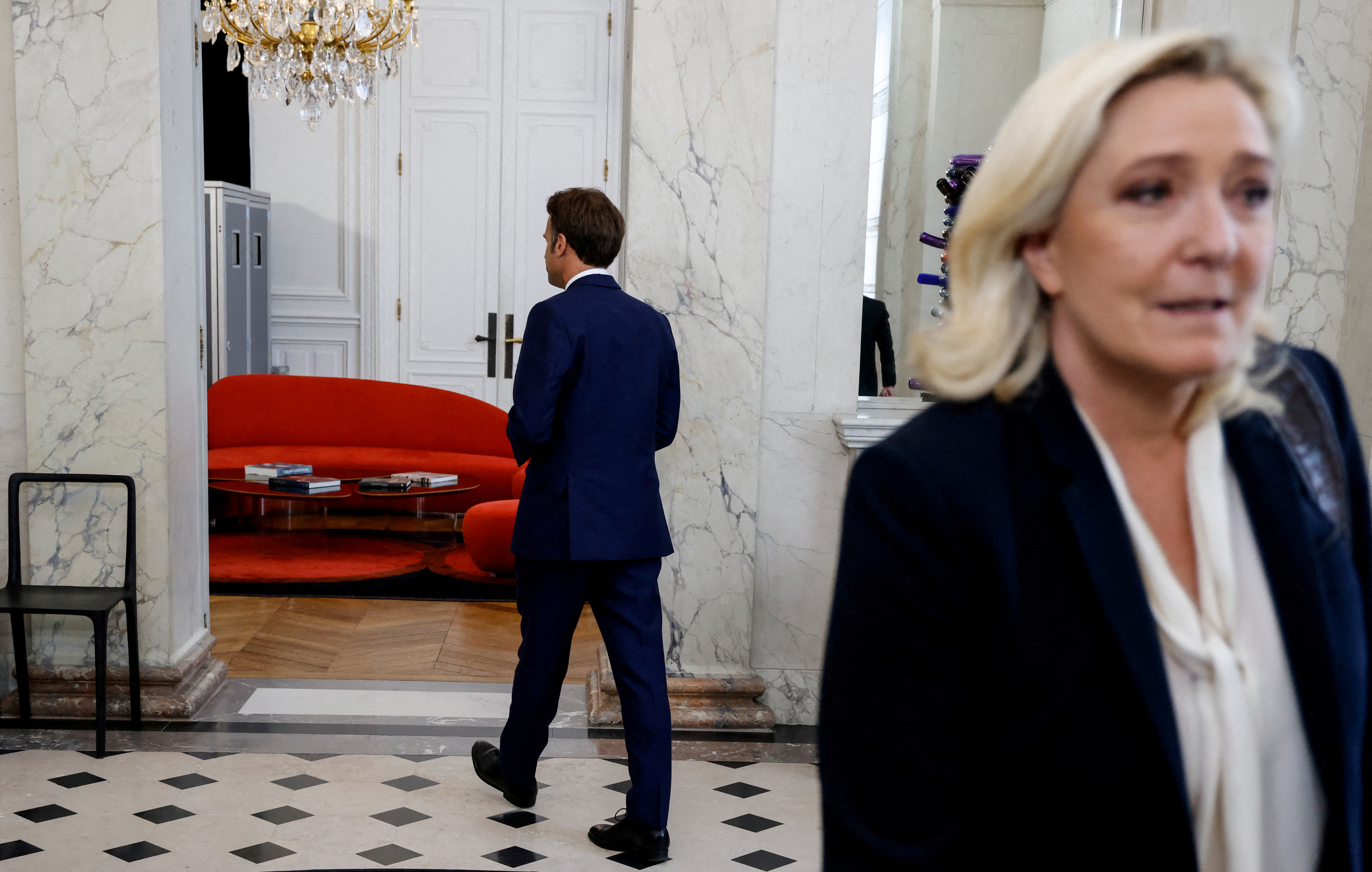 French far-right Rassemblement National (RN) leader and Member of Parliament Marine Le Pen walks away after being escorted by France's President Emmanuel Macron after talks at the presidential Elysee Palace, France, June 21, 2022. Ludovic Marin