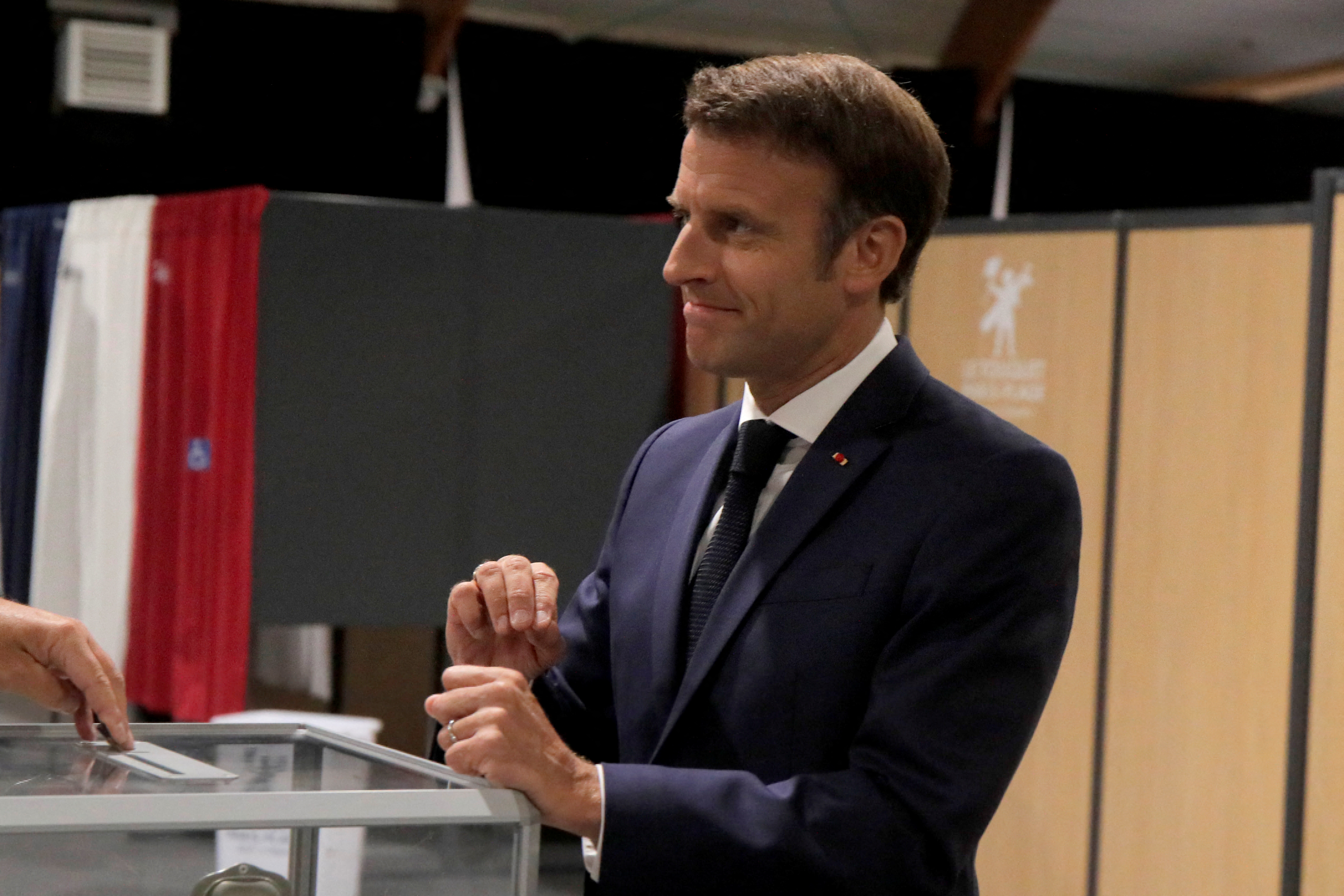French President Emmanuel Macron casts his ballot during the final round of the country's parliamentary elections, in Le Touquet, France June 19, 2022 Michel Spingler