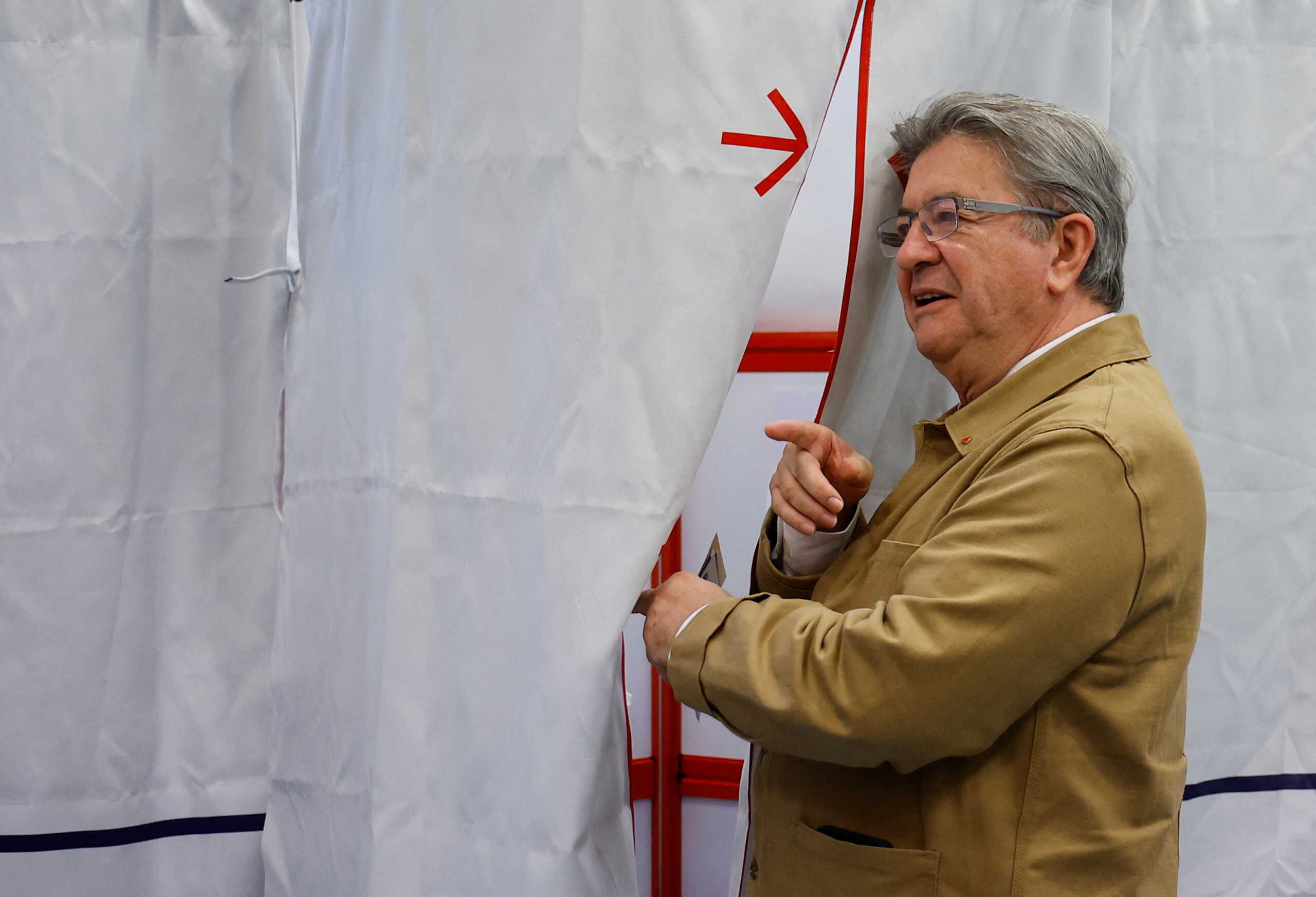 Jean-Luc Melenchon, leader of French far-left opposition party La France Insoumise (France Unbowed), member of Parliament and leader of left-wing coalition New Ecologic and Social People's Union (NUPES), enters a polling booth to vote in the first round of French parliamentary elections, at a polling station in Marseille, France, June 12, 2022. REUTERS