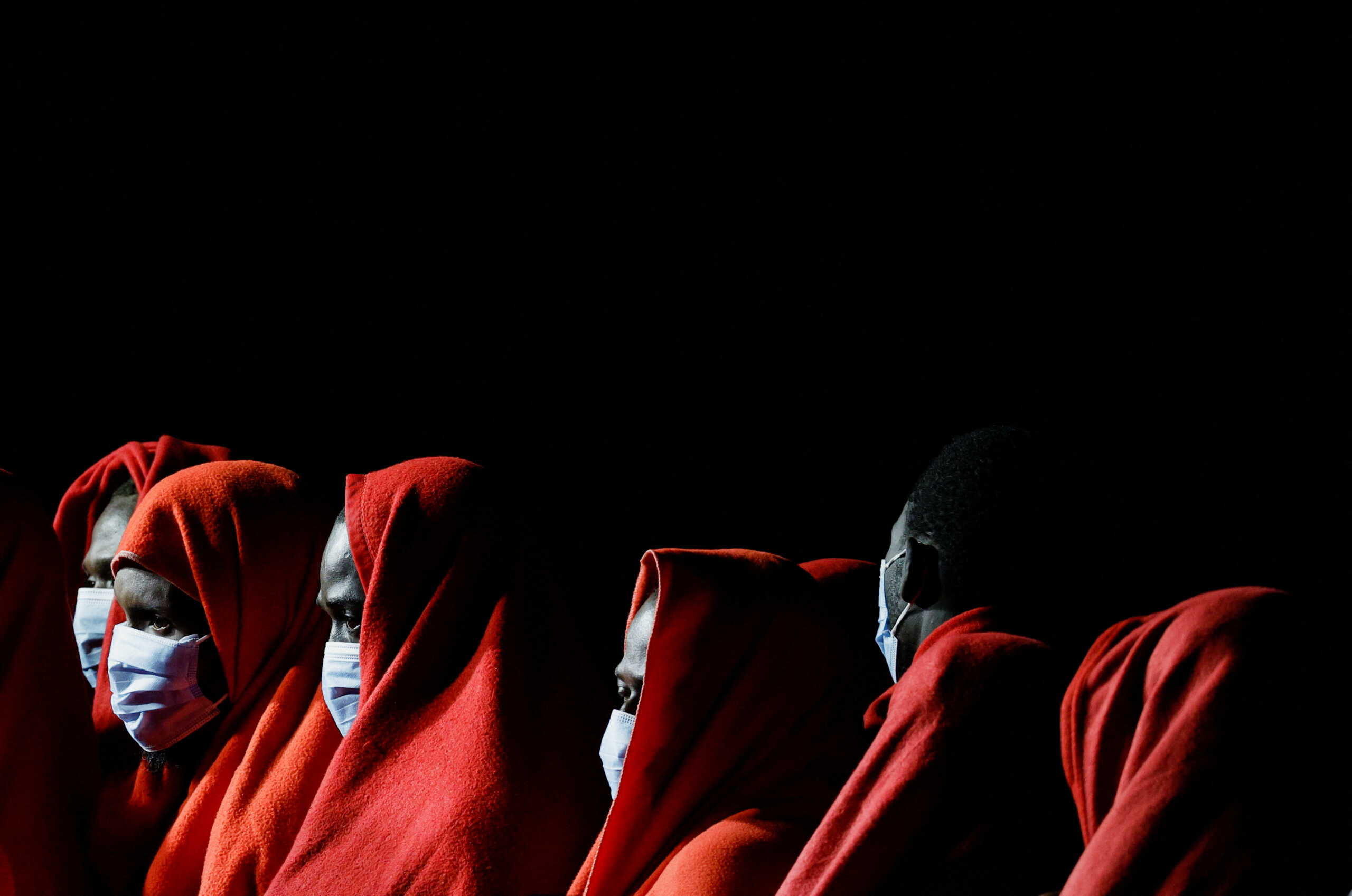 Migrants wait to disembark from a Spanish coast guard vessel, in the port of Arguineguin, in the island of Gran Canaria, Spain, May 30, 2022. REUTERS