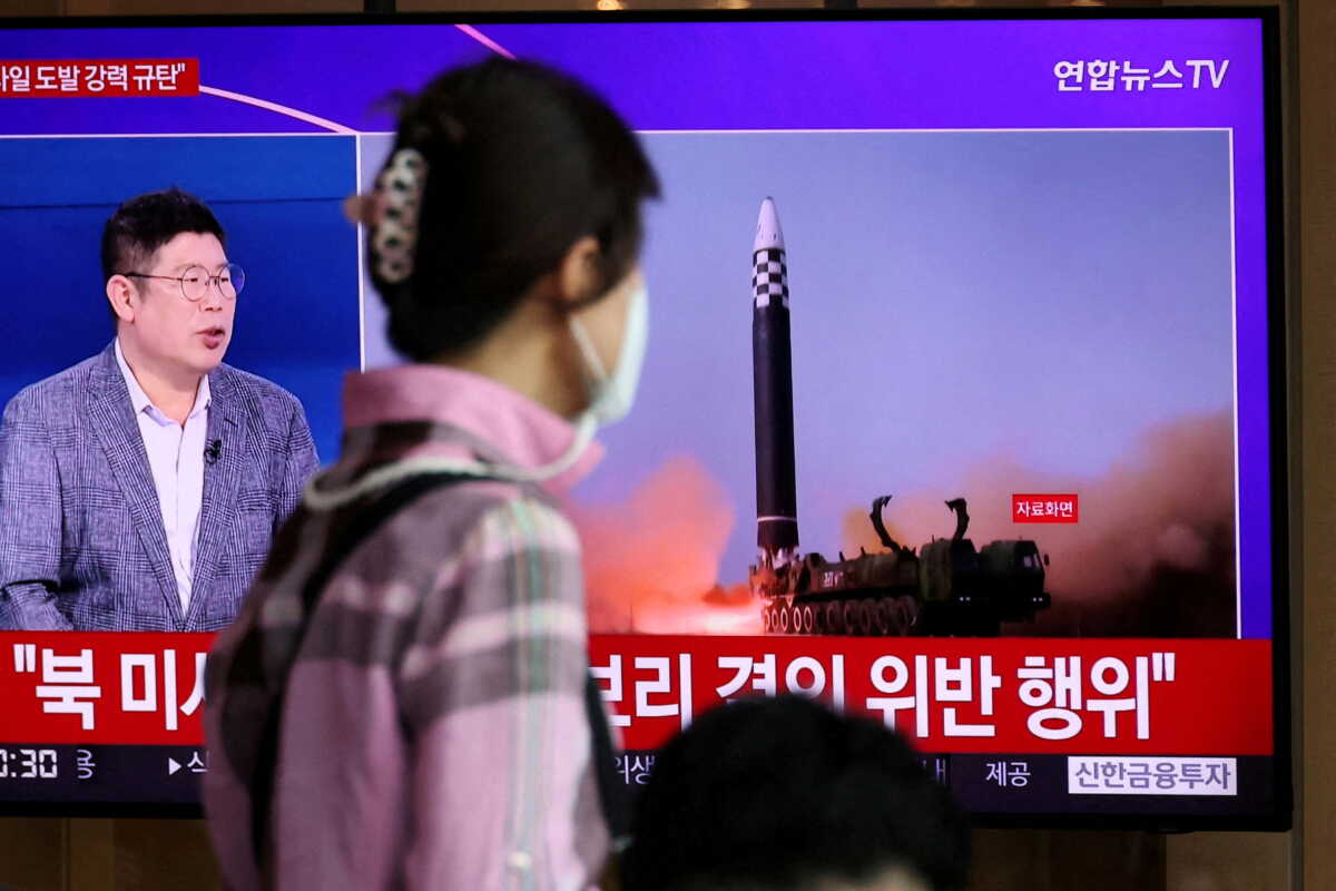 A woman watches a TV broadcasting a news report on North Korea's launch of three missiles including one thought to be an intercontinental ballistic missile (ICBM), in Seoul, South Korea, May 25, 2022.   REUTERS