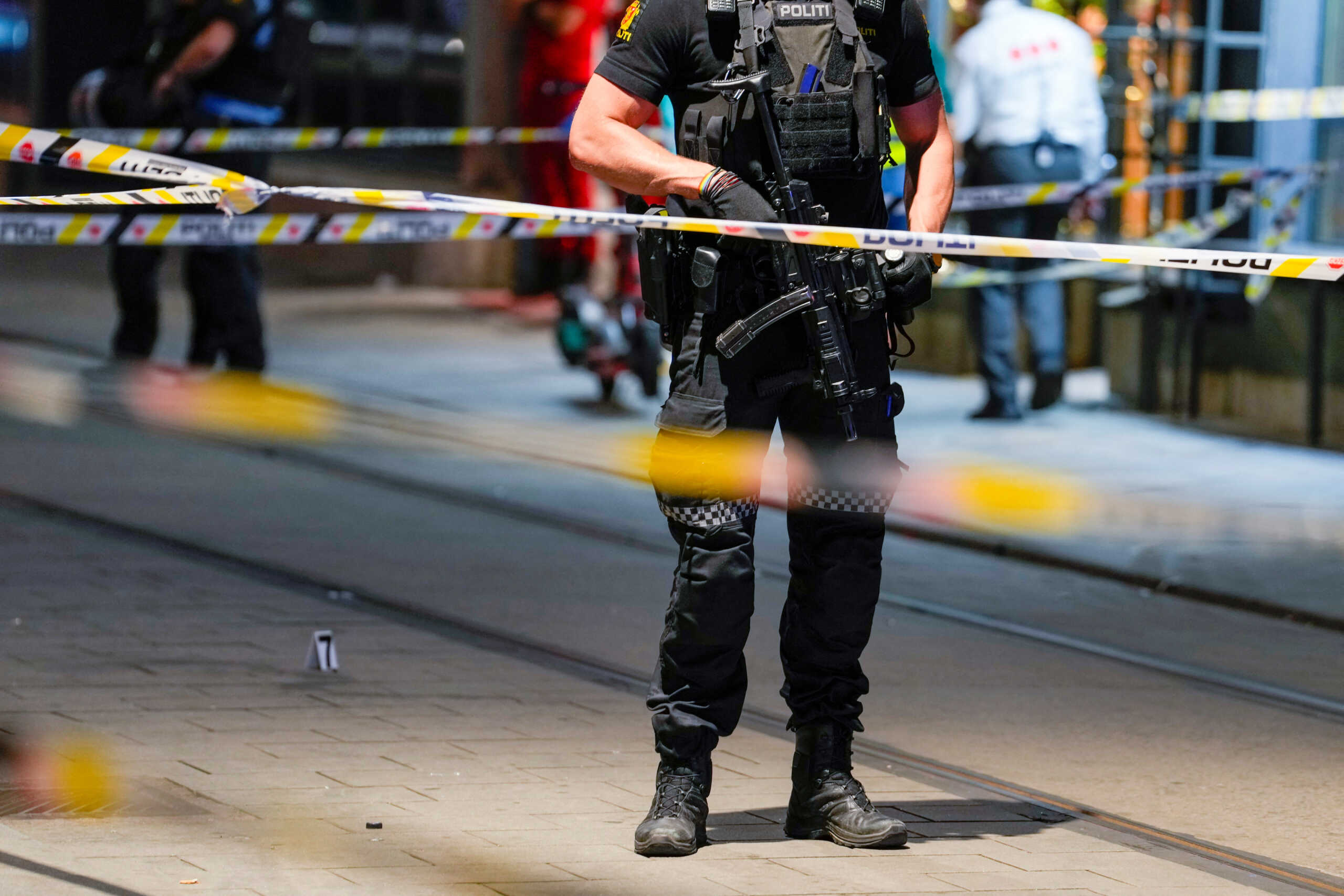A member of the security forces stands at the site where several people were injured during a shooting outside the London pub in central Oslo, Norway June 25, 2022. Javad Parsa