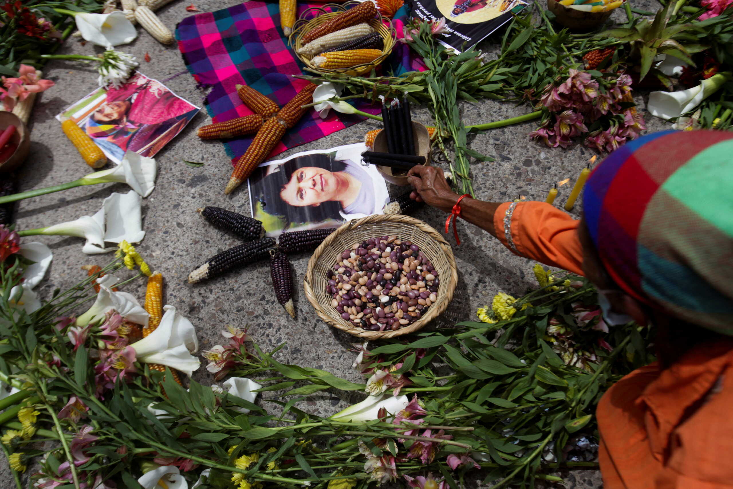 A demonstrator place candles as she protests outside the Supreme Court during a trial for Roberto David Castillo, a former top executive of a Desarrollos Energeticos (DESA), who was sentenced today to more than 22 years for his role in the 2016 murder of environmental activist Berta Caceres, in Tegucigalpa, Honduras June 20, 2022. REUTERS