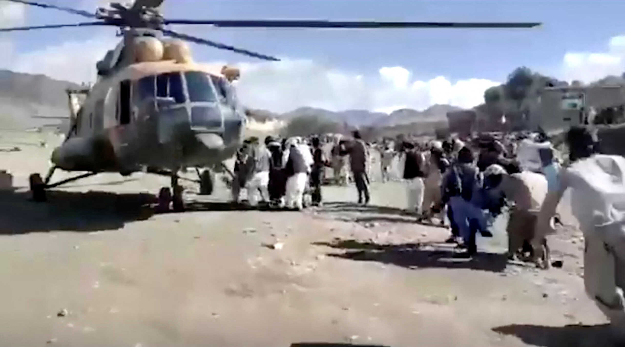 People carry injured to a helicopter following a massive earthquake, in Paktika Province, Afghanistan, June 22, 2022, in this screen grab taken from a video. BAKHTAR NEWS AGENCY