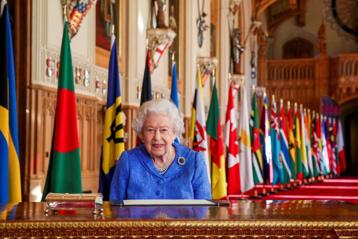 FILE PHOTO: Britain's Queen Elizabeth II signs her annual Commonwealth Day message in St George's Hall at Windsor Castle, Britain, in this picture issued March 5, 2021. Steve Parsons