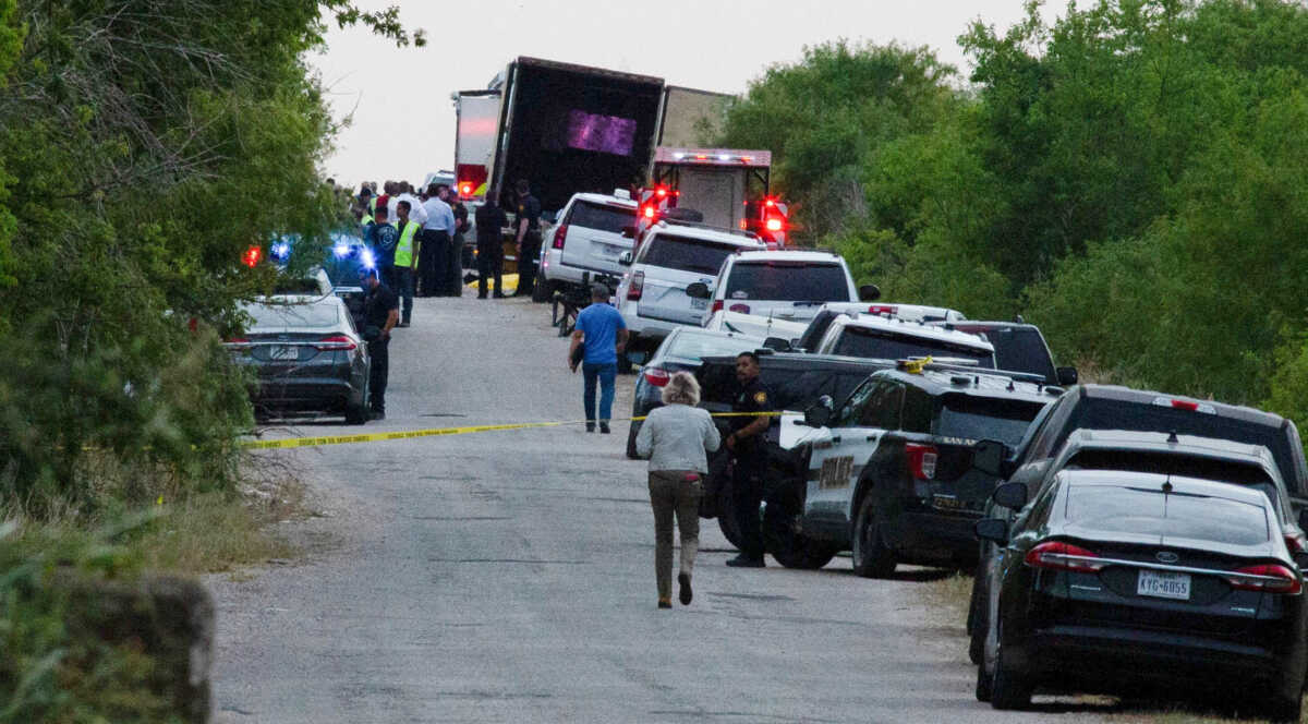Law enforcement officers work at the scene where people were found dead inside a trailer truck in San Antonio, Texas, U.S. June 27, 2022. REUTERS