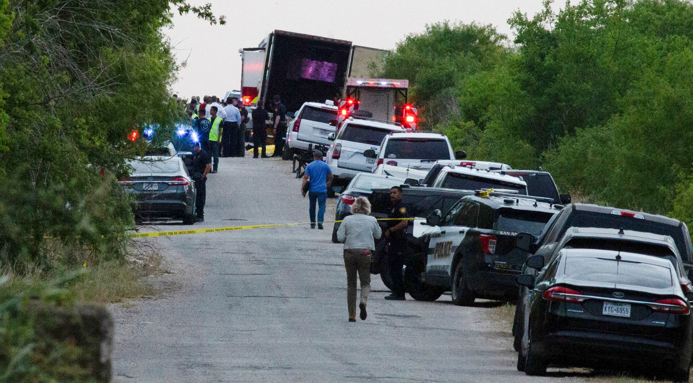 Law enforcement officers work at the scene where people were found dead inside a trailer truck in San Antonio, Texas, U.S. June 27, 2022. REUTERS