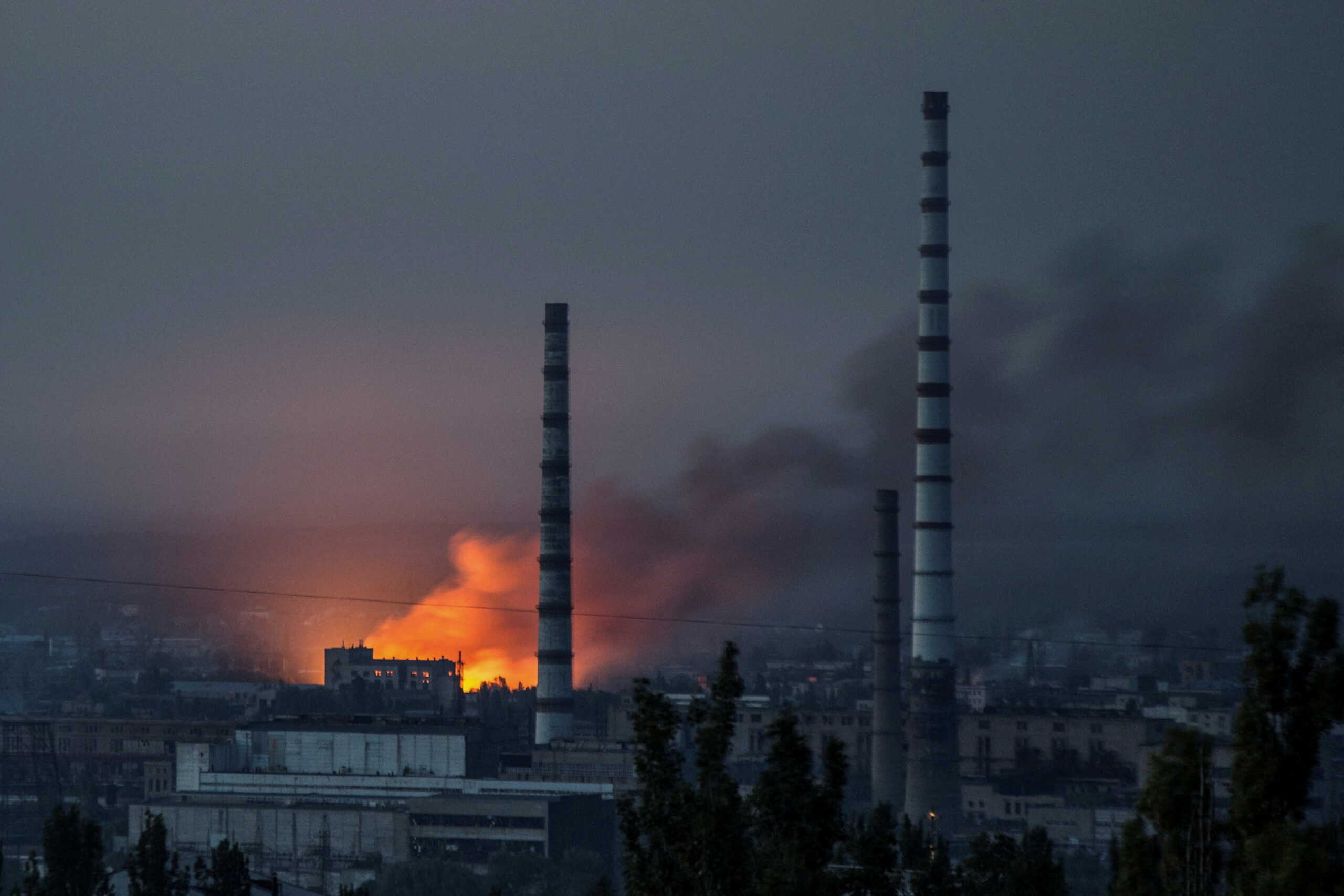 Smoke and flame rise after a military strike on a compound of Sievierodonetsk's Azot Chemical Plant, as Russia's attack on Ukraine continues, in Lysychansk, Luhansk region, Ukraine June 18, 2022. REUTERS