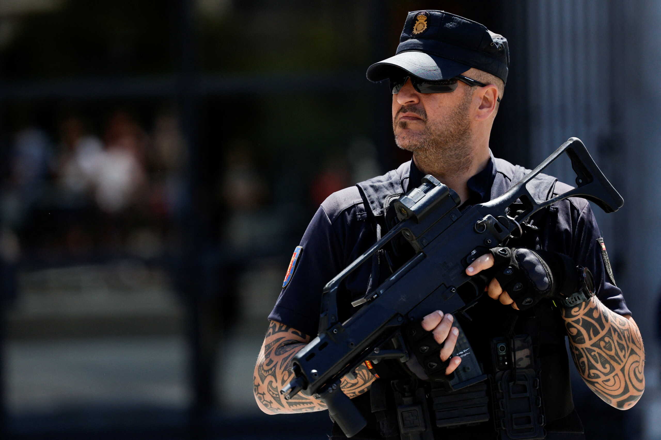 A Spanish police officer keeps guard outside the venue during a ceremony to commemorate Spain's accession to NATO in 1982 at the Royal Theatre in Madrid, Spain, May 30, 2022. REUTERS