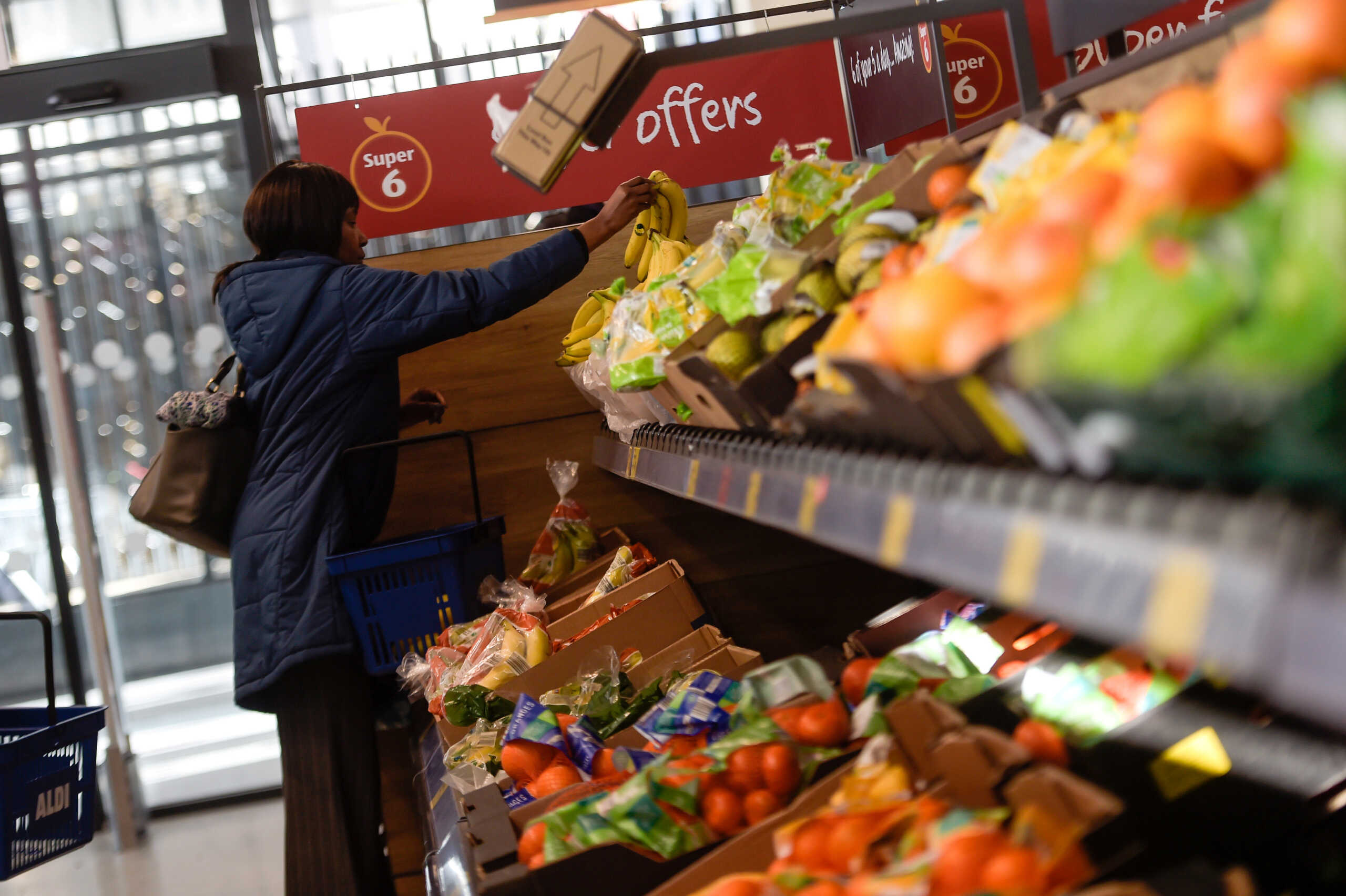 A shopper selects fruit in an Aldi store in London, Britain, February 15, 2018. REUTERS