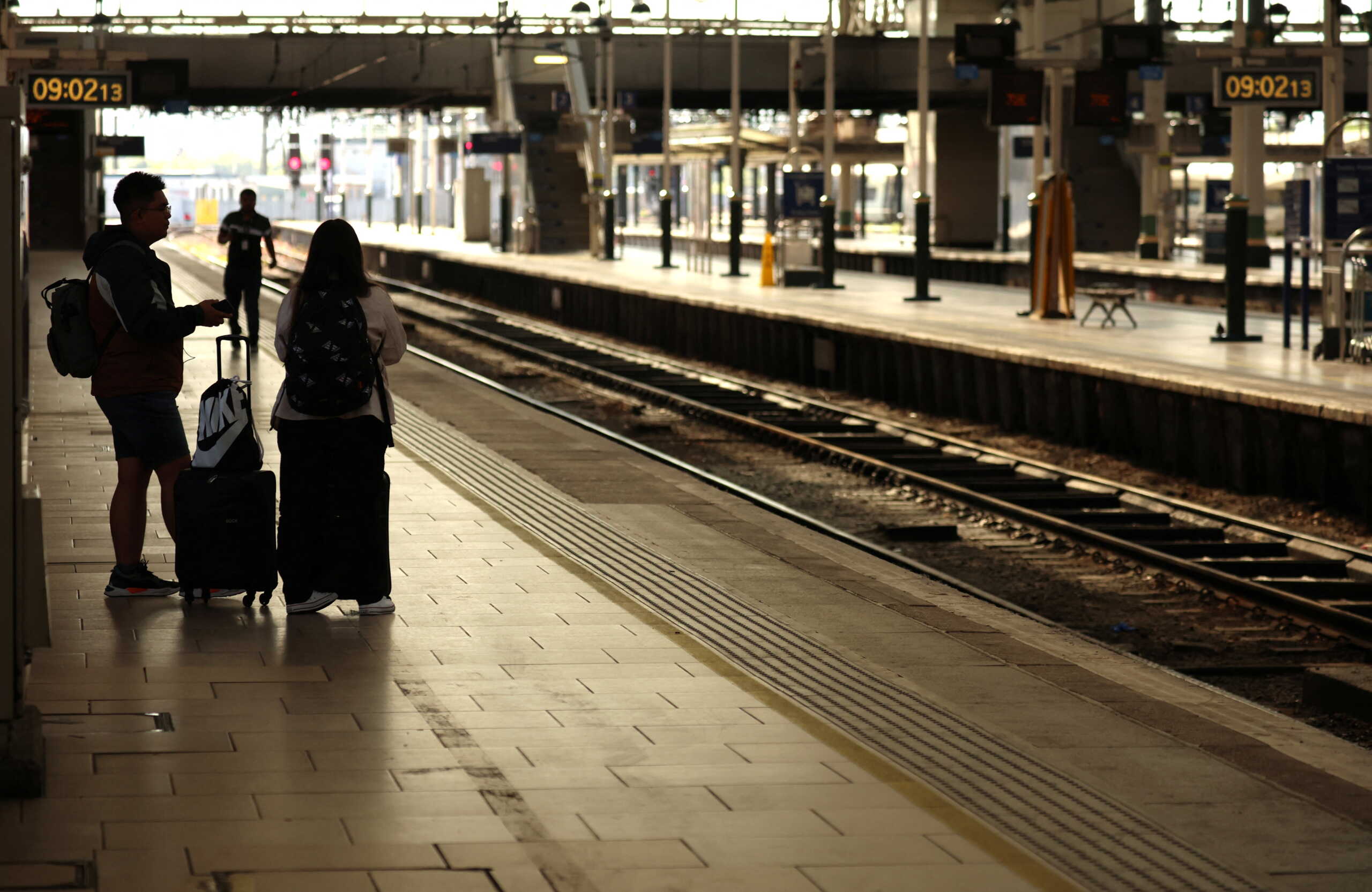 People wait on an empty platform on the first day of a national rail strike at Manchester Piccadilly Station in Manchester, Britain, June 21, 2022. REUTERS