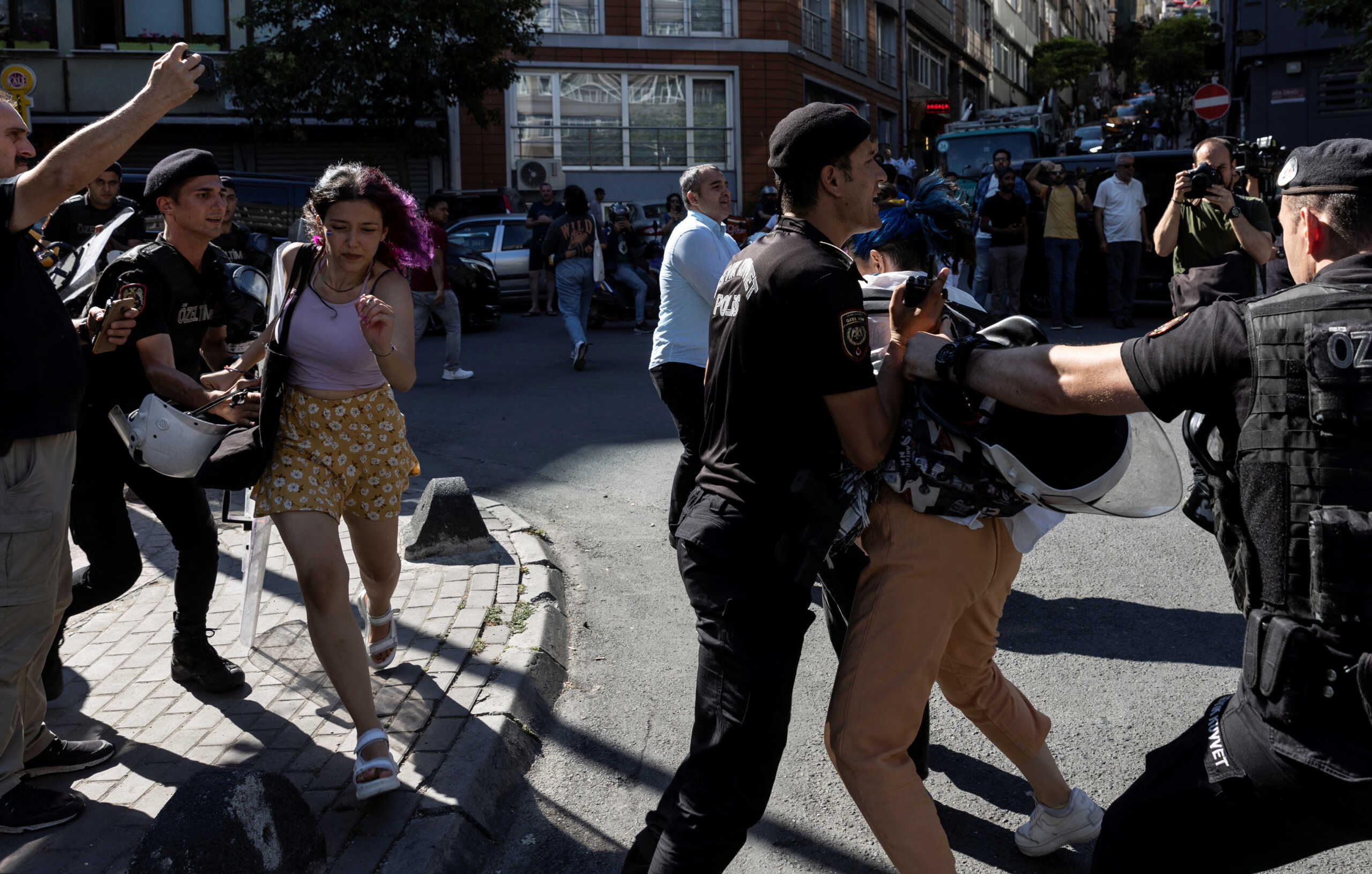 Police officers detain activists to prevent them from marching in a pride parade, which was banned by local authorities, in central Istanbul, Turkey June 26, 2022. REUTERS