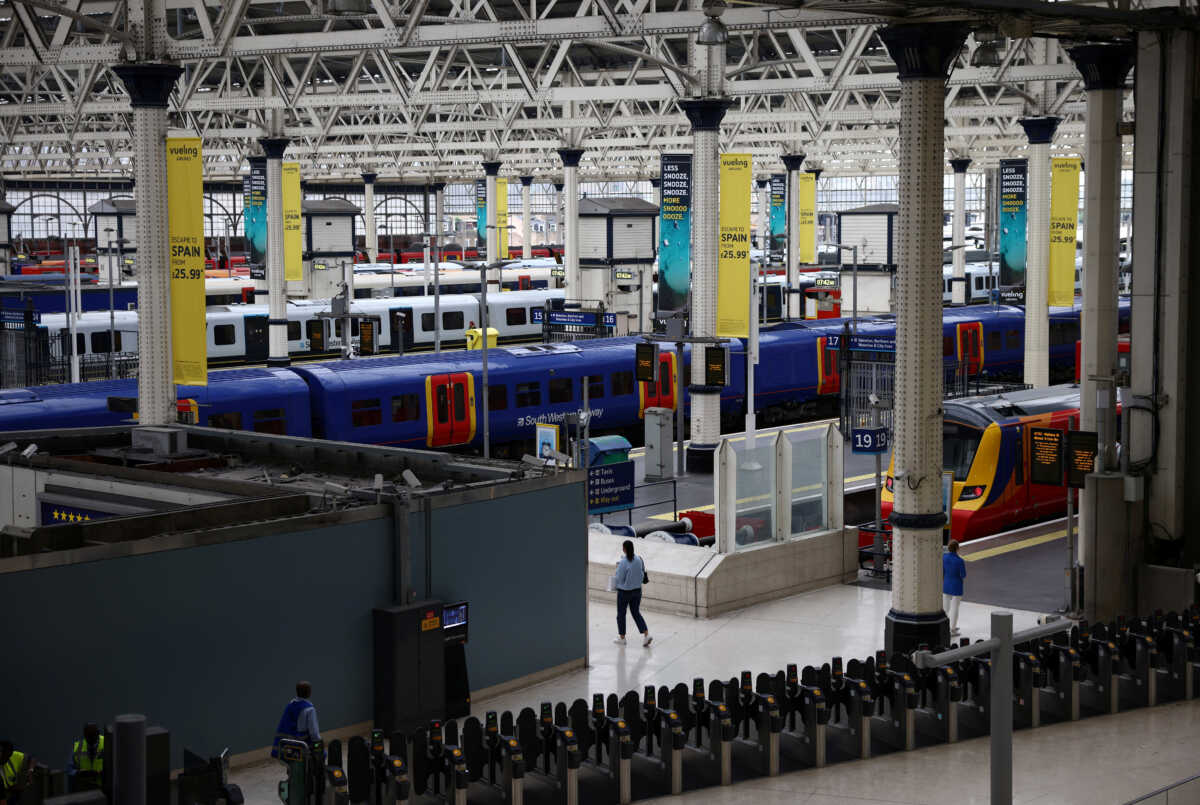 A commuter walks through Waterloo station, on the third day of national rail strikes, in London, Britain, June 23, 2022. REUTERS