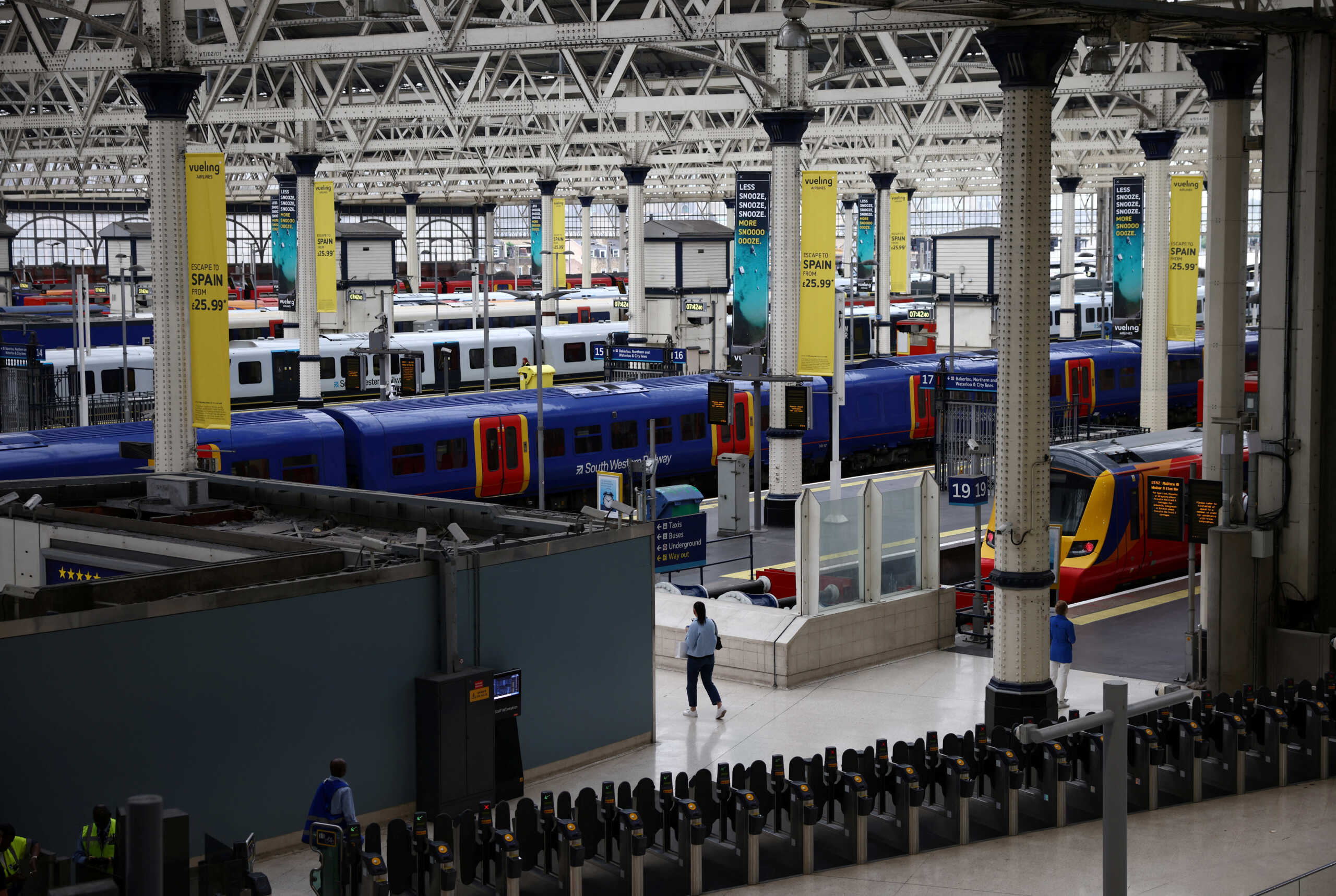 A commuter walks through Waterloo station, on the third day of national rail strikes, in London, Britain, June 23, 2022. REUTERS