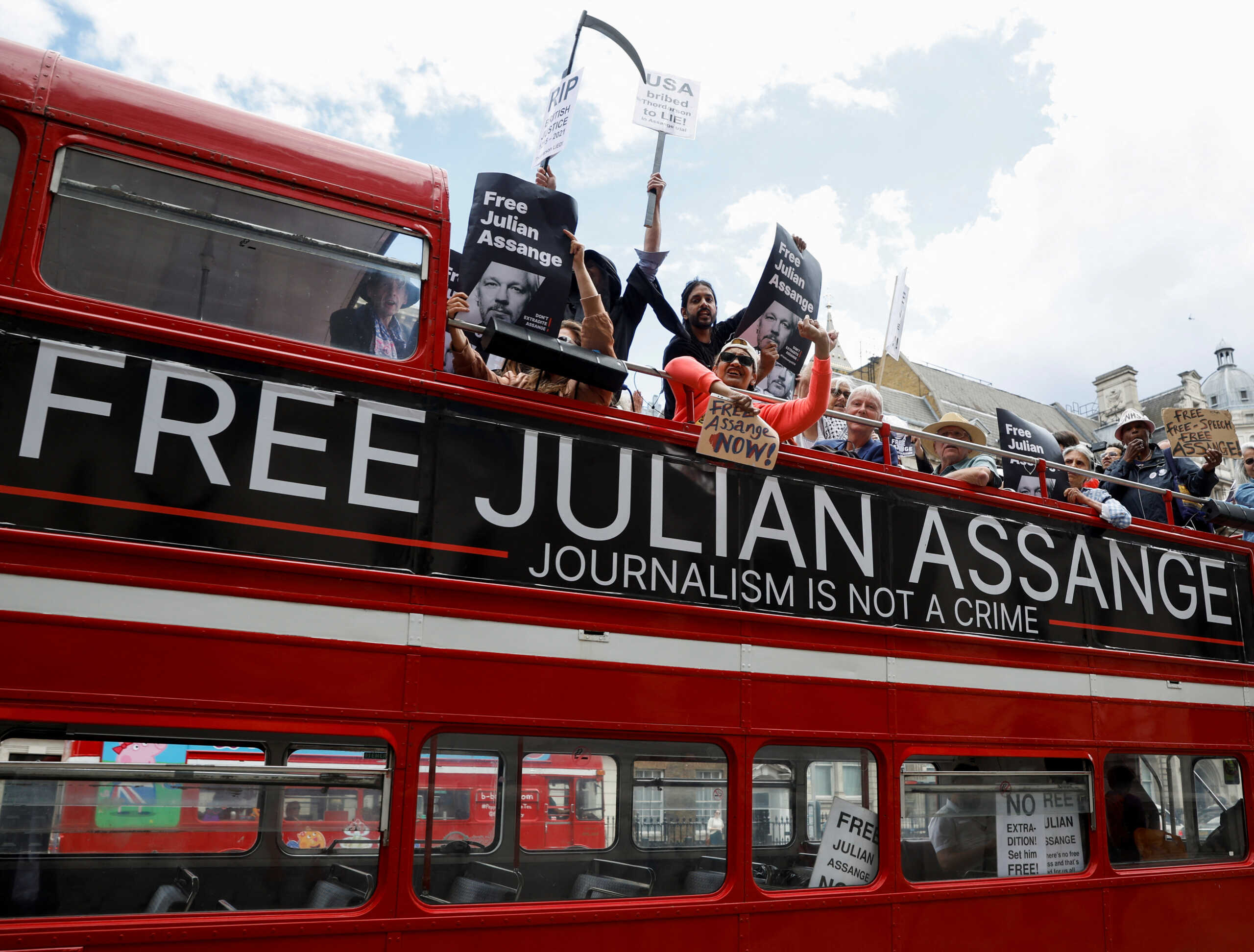 Protesters ride on a bus during a 'Free Assange' demonstration to mark WikiLeaks founder Julian Assange's birthday, in London, Britain, July 1, 2022. REUTERS