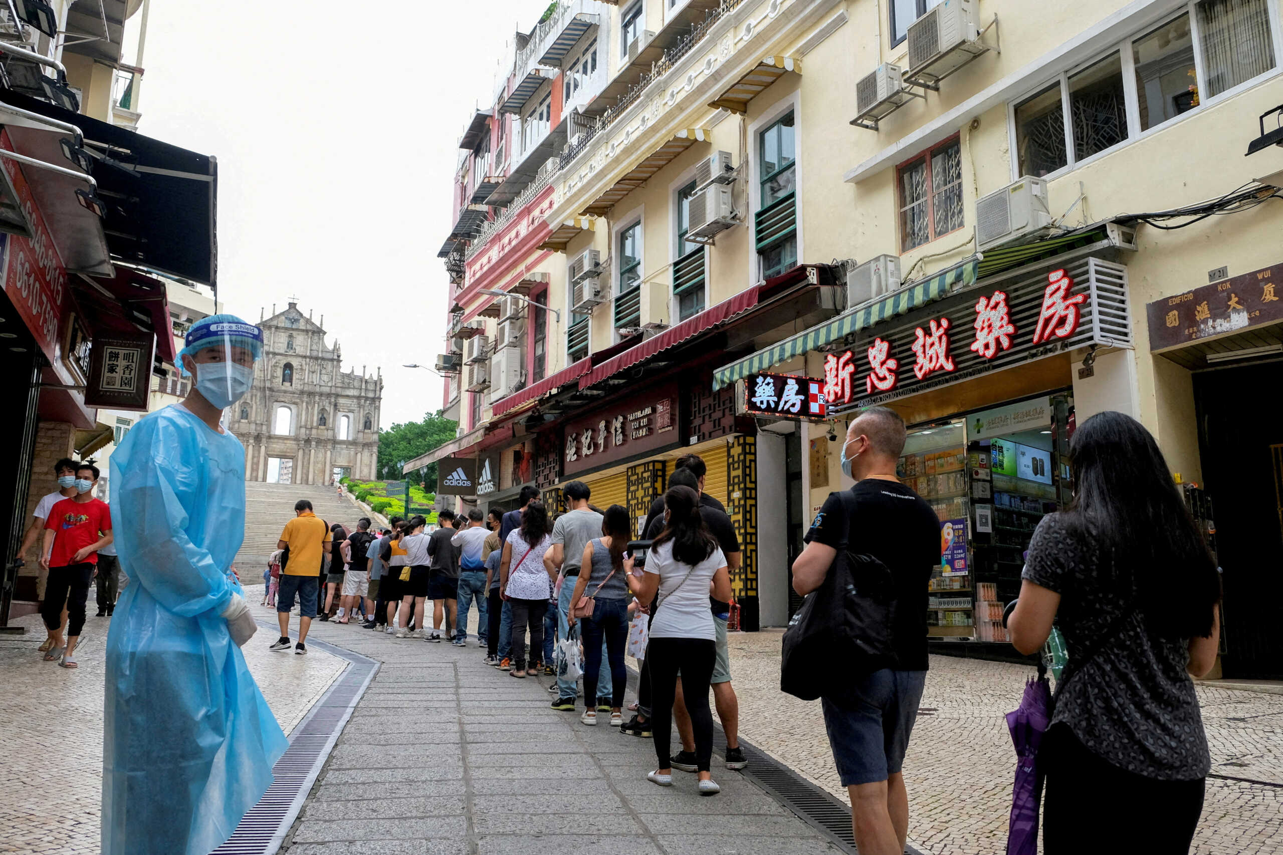 FILE PHOTO: People queue for COVID-19 testing in Macau, China, June 20, 2022. REUTERS