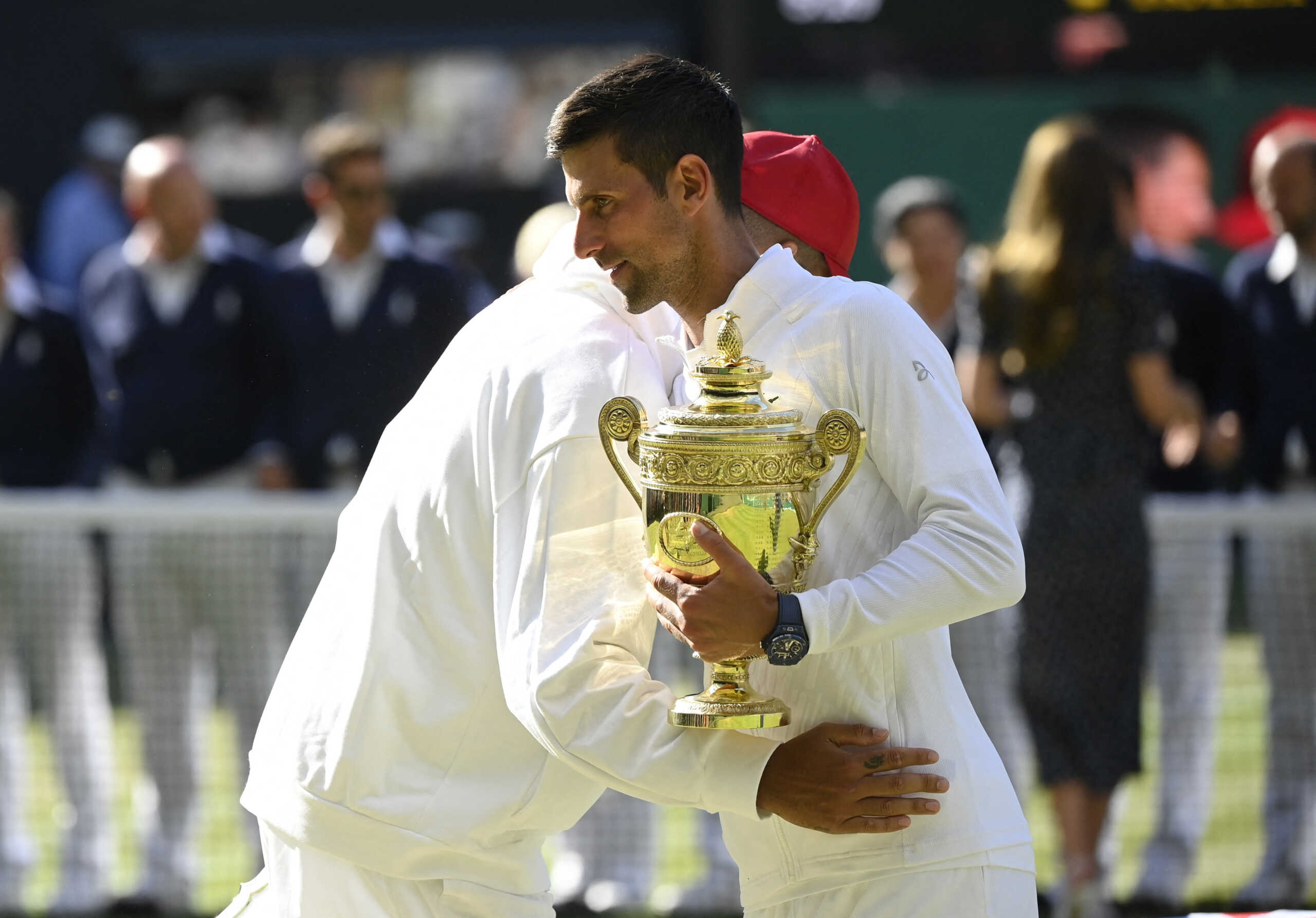 Tennis - Wimbledon - All England Lawn Tennis and Croquet Club, London, Britain - July 10, 2022 Serbia's Novak Djokovic celebrates with the trophy after winning the men's singles final alongside runner up Australia's Nick Kyrgios REUTERS
