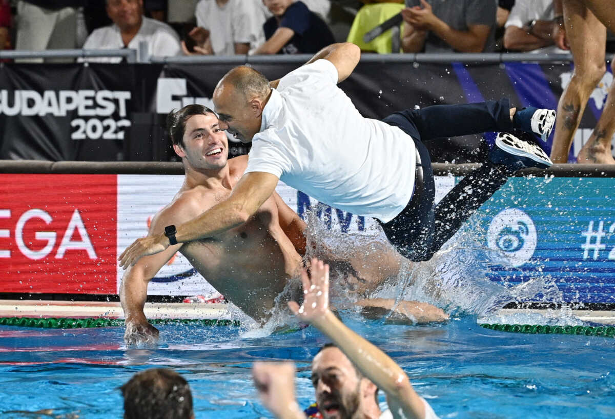 Water Polo - FINA World Championships - Men's Gold Medal Match - Italy v Spain - Alfred Hajos Swimming Complex, Budapest, Hungary - July 3, 2022 Head coach of team Spain David Martin Lozano celebrates by jumping in the pool after winning the Men's Gold Medal Match REUTERS
