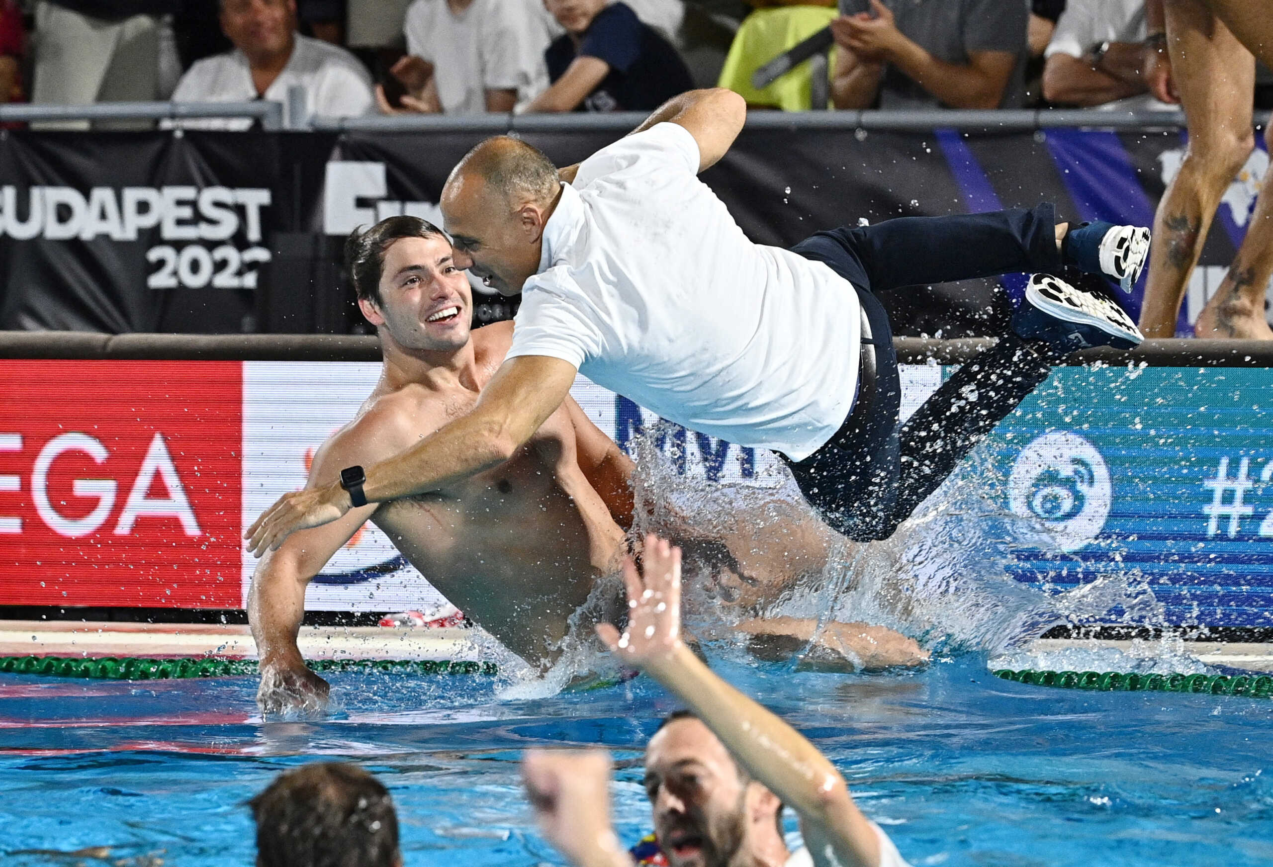 Water Polo - FINA World Championships - Men's Gold Medal Match - Italy v Spain - Alfred Hajos Swimming Complex, Budapest, Hungary - July 3, 2022 Head coach of team Spain David Martin Lozano celebrates by jumping in the pool after winning the Men's Gold Medal Match REUTERS