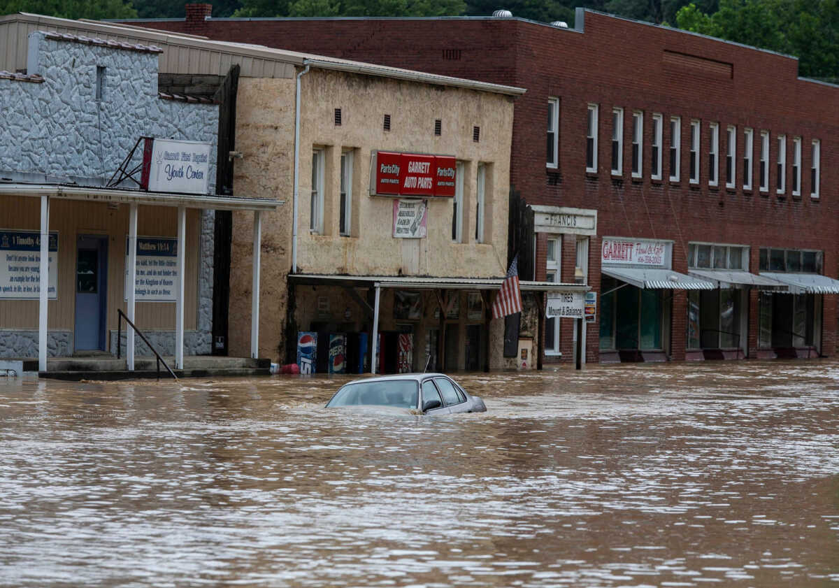 A car is submerged in flood waters along Right Beaver Creek, following a day of heavy rain in in Garrett, Kentucky, U.S. July 28, 2022.  Pat McDonogh