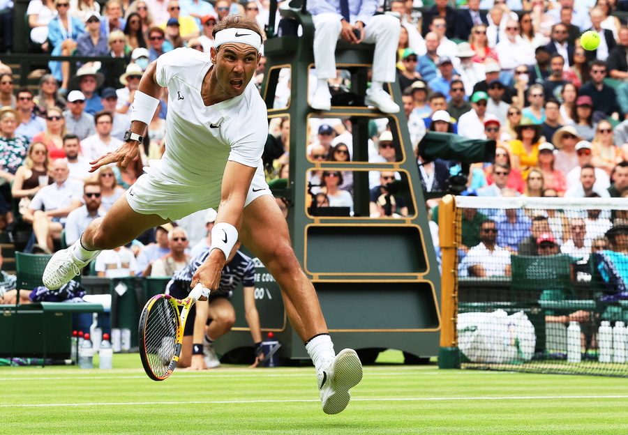 epa10055424 Rafael Nadal of Spain in action against Taylor Fritz of the USA during their men's quarter final match at the Wimbledon Championships in Wimbledon, Britain, 06 July 2022.  EPA