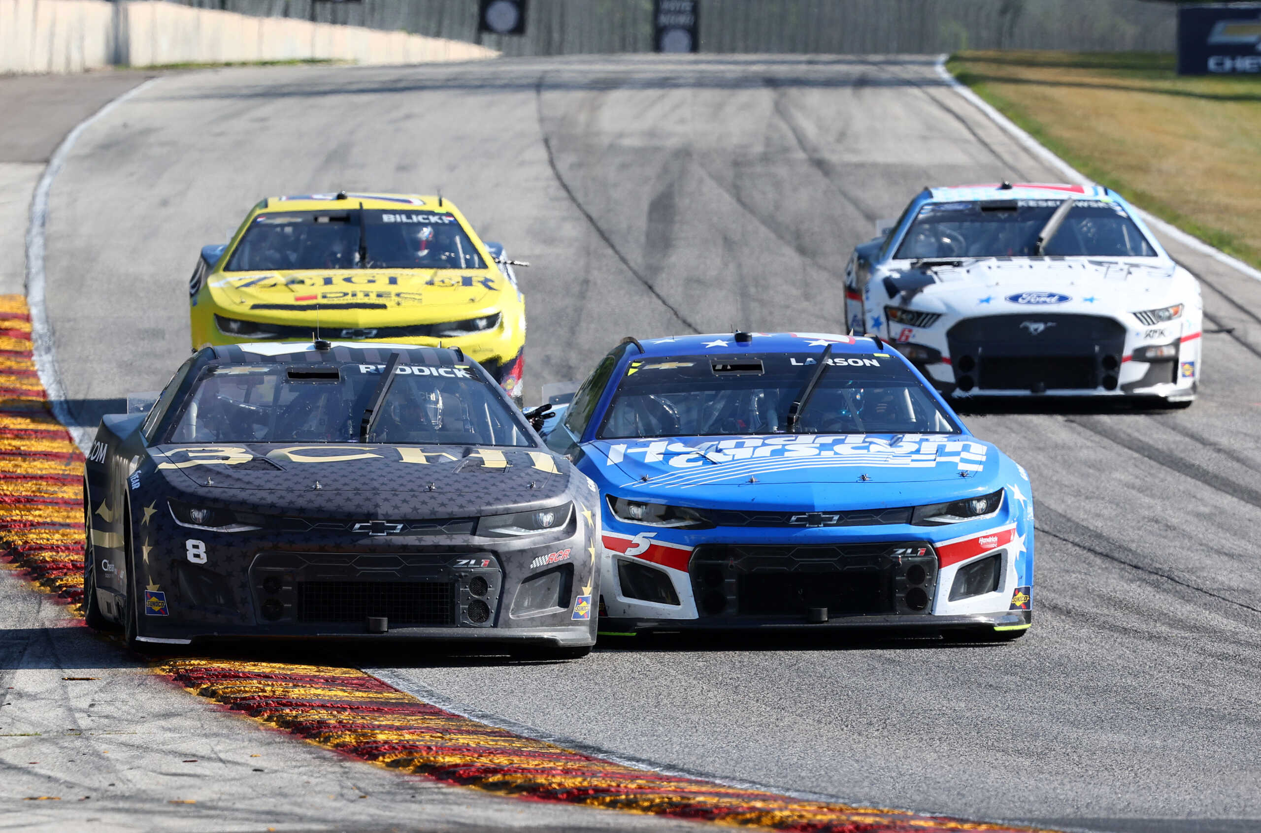 Jul 3, 2022; Elkhart Lake, Wisconsin, USA; NASCAR Cup Series driver Tyler Reddick (8) reacts after winning the KWIK TRIP 250 with driver Kyle Larson (5) at Road America. Mandatory Credit: Mike Dinovo-USA TODAY Sports