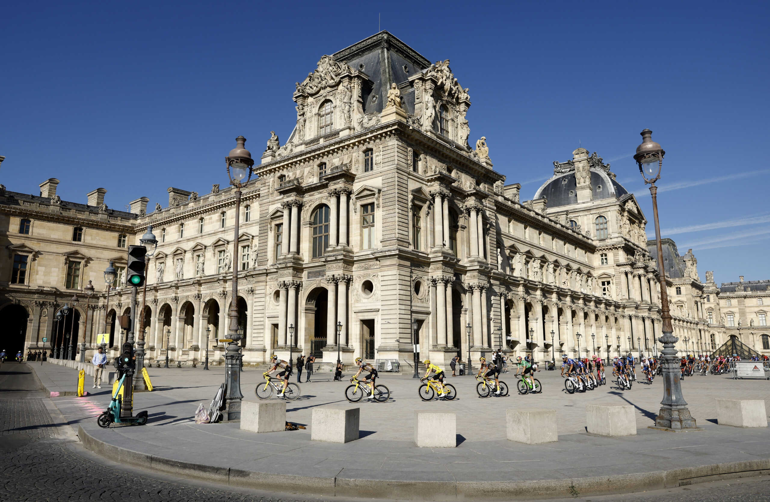 Cycling - Tour de France - Stage 21 - Paris La Defense Arena to Champs-Elysees - France - July 24, 2022 General view of riders passing the Louvre museum during stage 21 REUTERS