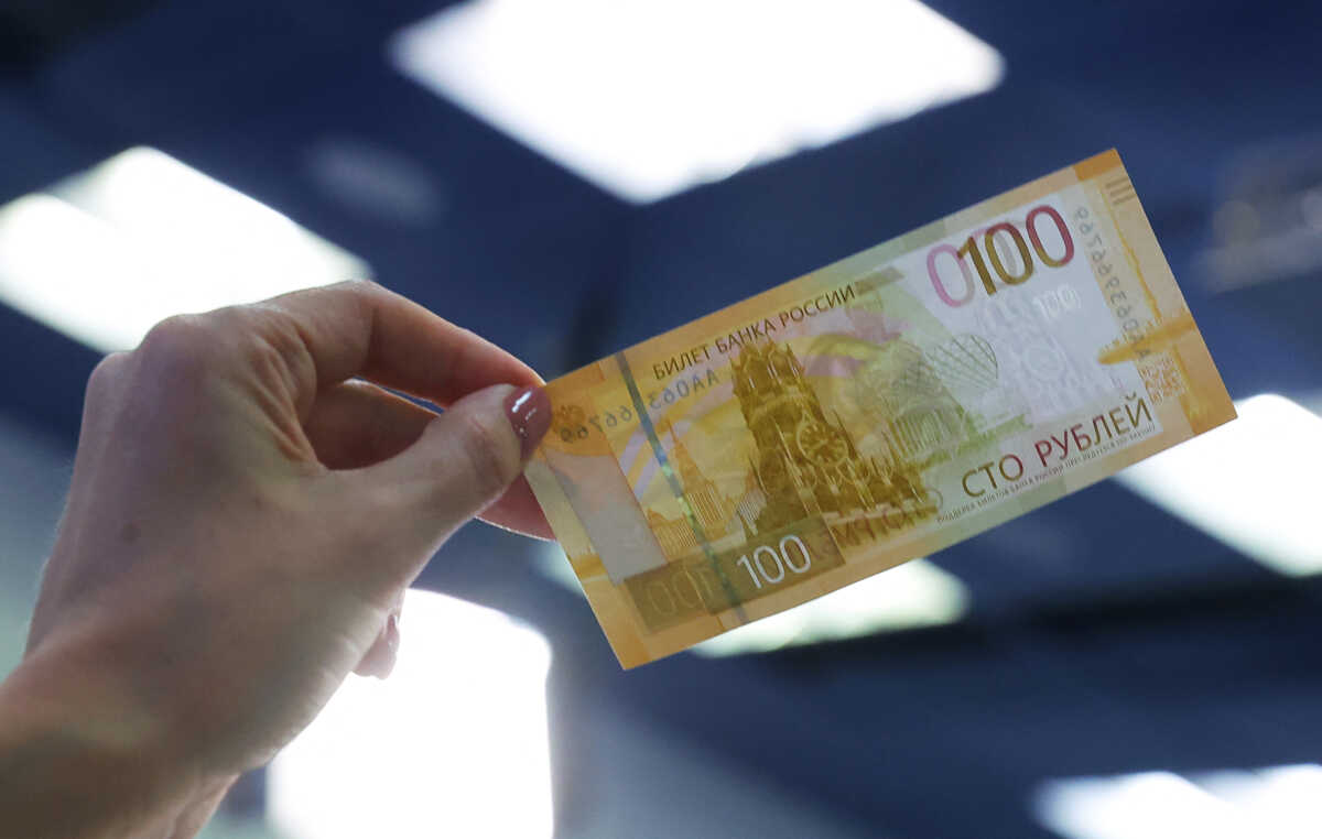 A person holds the newly designed Russian 100-rouble banknote during a presentation in Moscow, Russia June 30, 2022. REUTERS