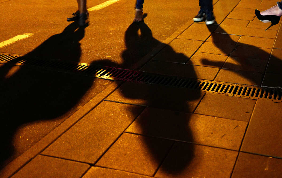 People cast their shadows outside a bar in Moscow, Russia July 13, 2018. Picture taken July 13, 2018.  REUTERS