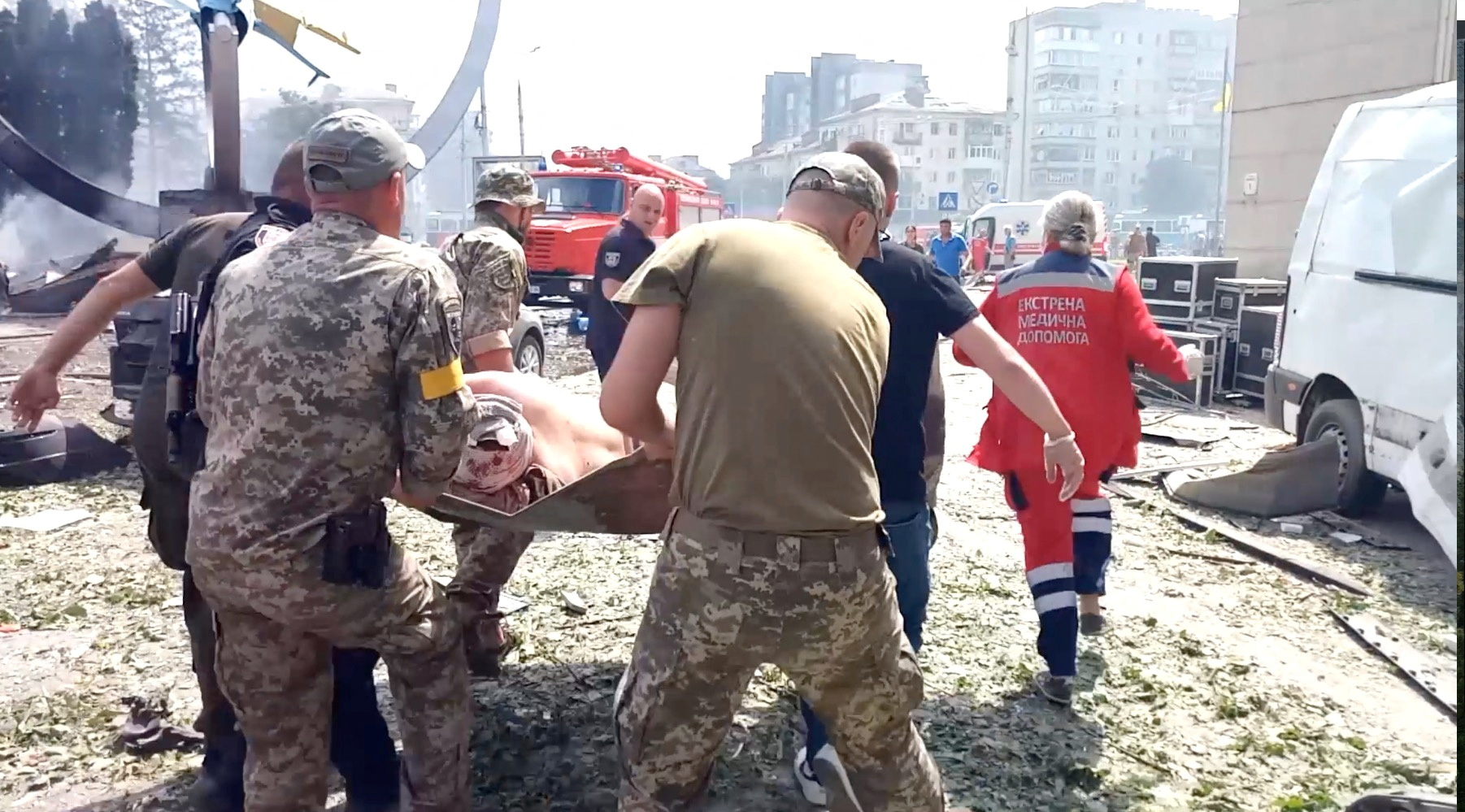 SENSITIVE MATERIAL. THIS IMAGE MAY OFFEND OR DISTURB    Rescuers carry the body of a person at the site of a Russian military strike, as Russia's attack on Ukraine continues, in Vinnytsia, Ukraine July 14, 2022 in this still image obtained from a handout video. Air Force Command of Ukraine Armed Forces