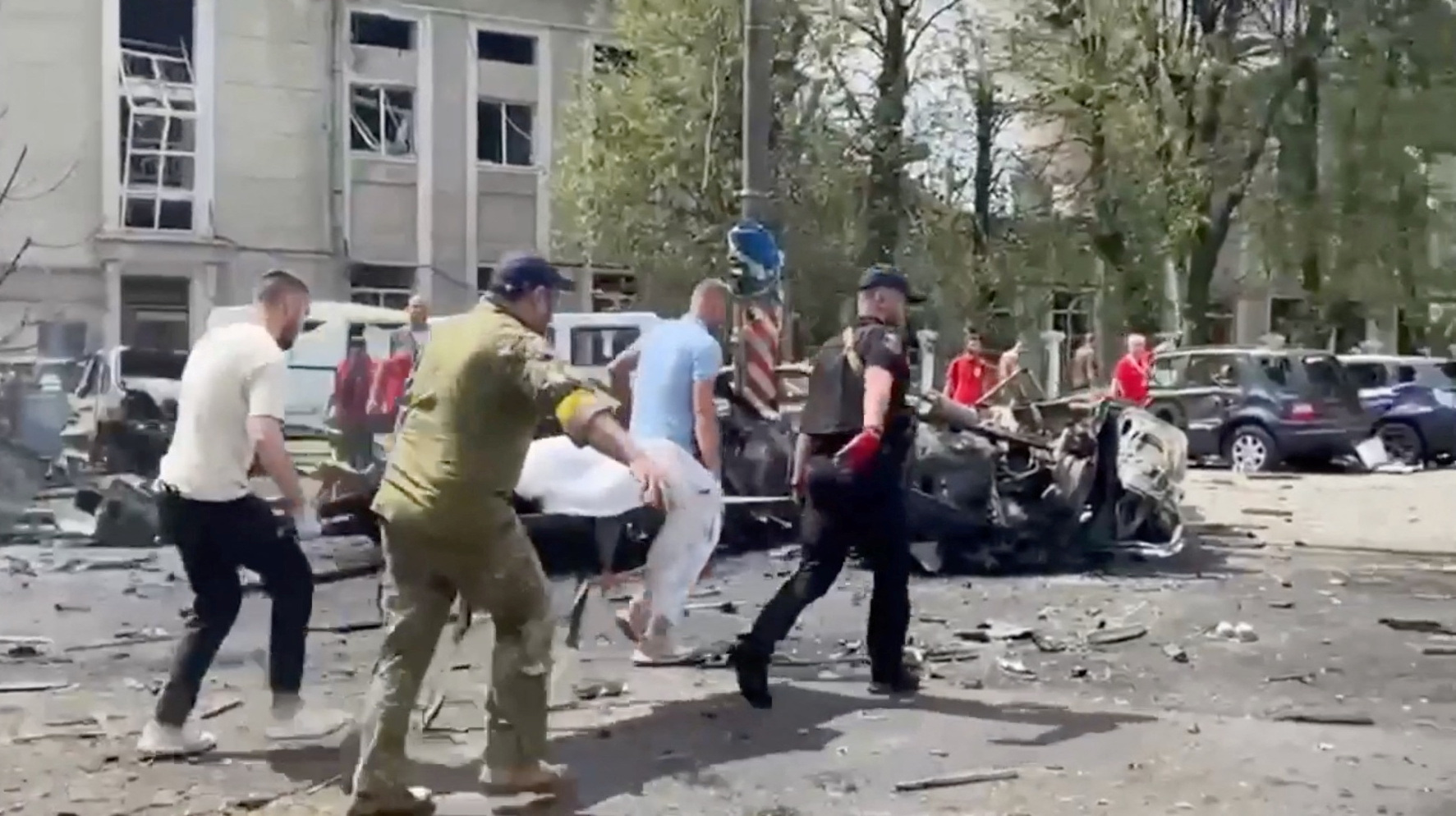 Rescuers carry the body of a person, at the site of a Russian military strike, as Russia's attack on Ukraine continues, in Vinnytsia, Ukraine July 14, 2022. National Police of Ukraine