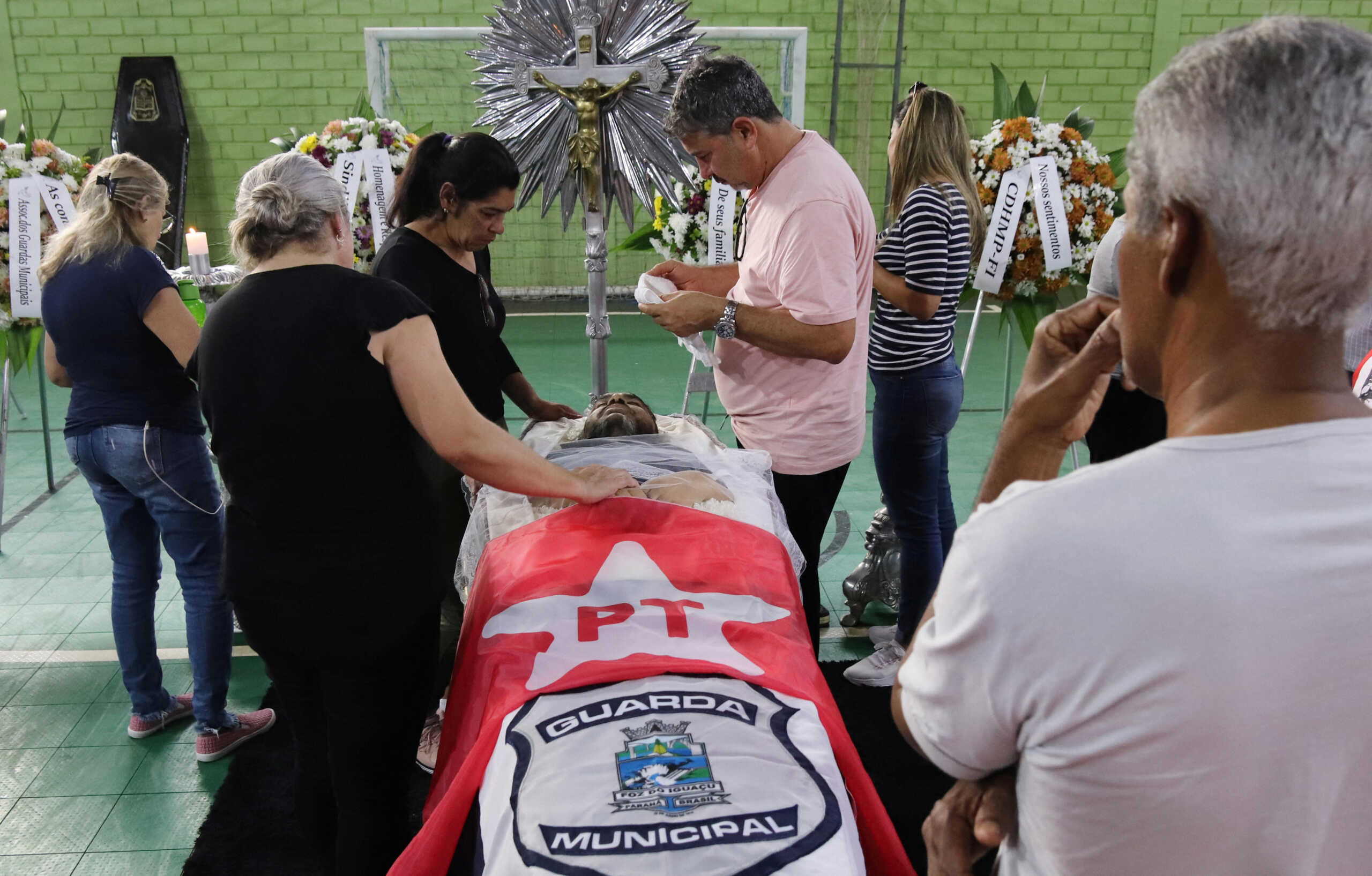 Relatives and friends of Marcelo Arruda, supporter of Brazilian former President Luiz Inacio Lula da Silva killed by an alleged supporter of Brazilian President Bolsonaro, mourn next to his coffin in Foz do Iguacu, Brazil, July 10, 2022. REUTERS