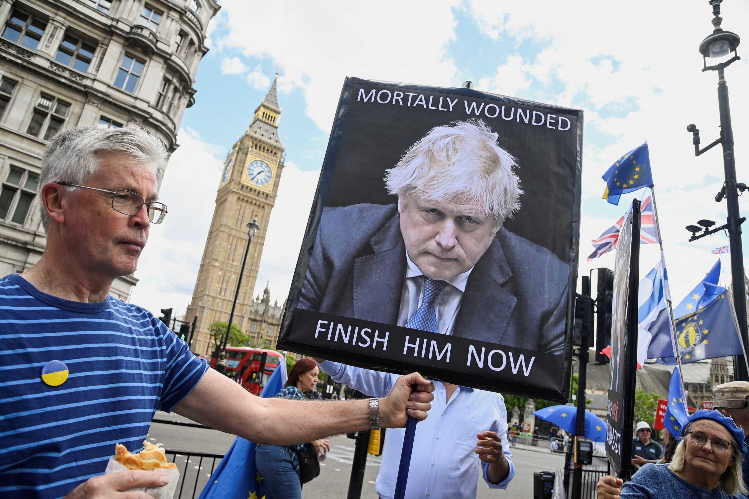 Protestors hold placards depicting British Prime Minister Boris Johnson outside of the Houses of Parliament, in London, Britain, June 8, 2022. REUTERS
