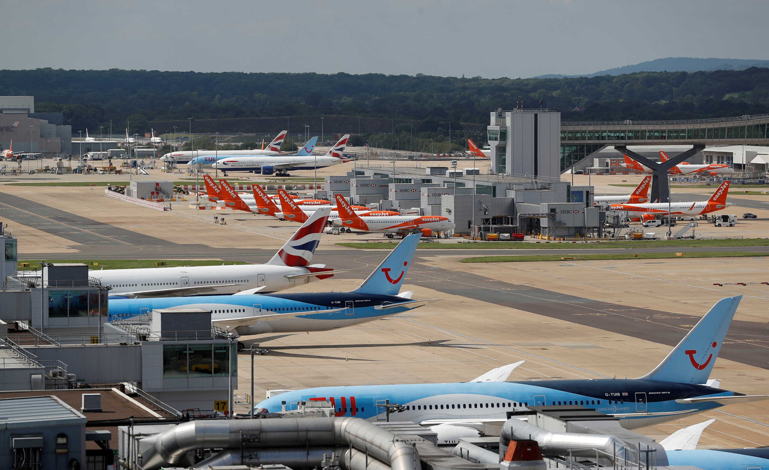 FILE PHOTO: British Airways, Easyjet and TUI aircraft are parked at the South Terminal at Gatwick Airport, in Crawley, Britain, August 25, 2021.  REUTERS