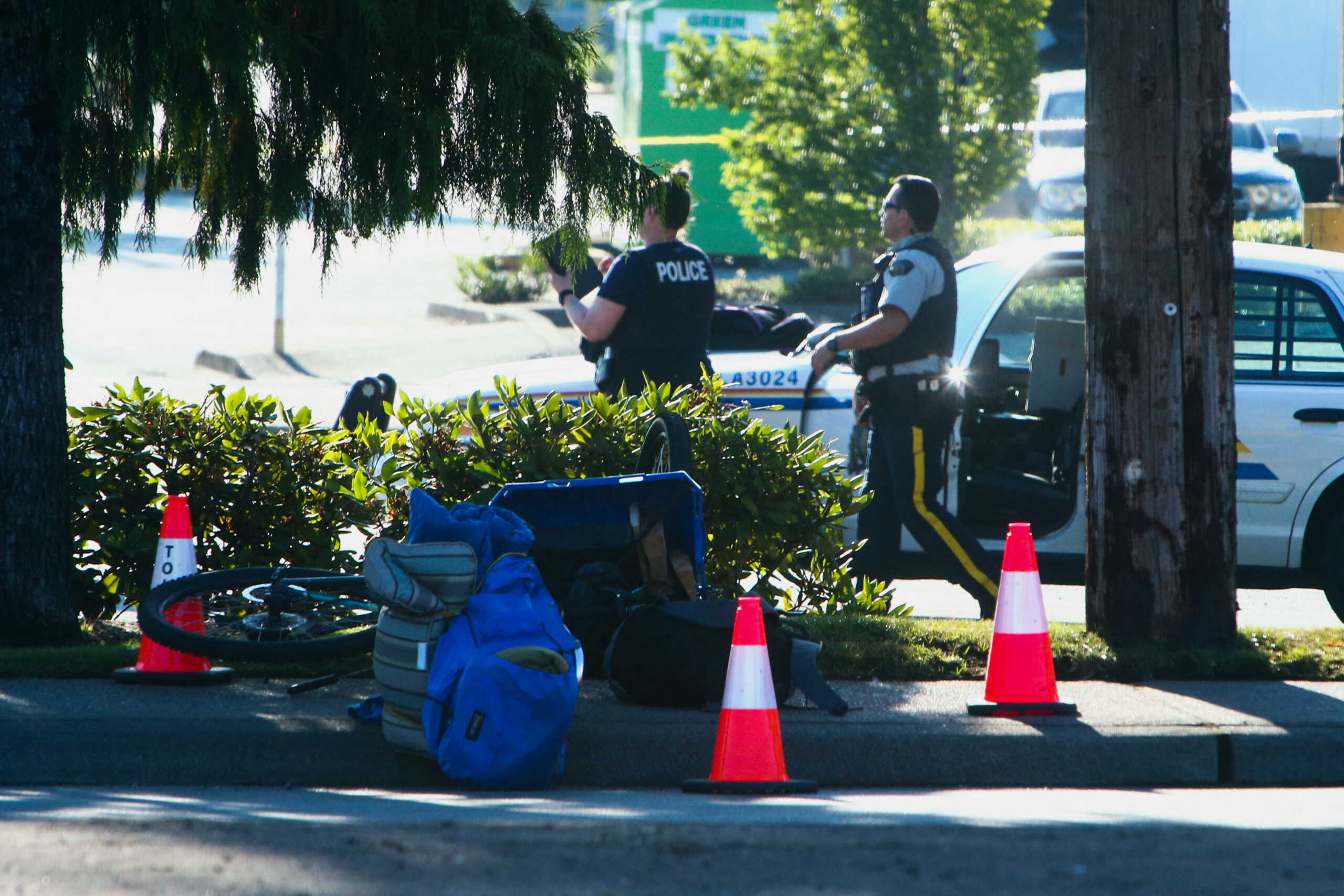 Police officers work at the site after authorities alerted residents of multiple shootings targeting transient victims in the Vancouver suburb of Langley, British Columbia, Canada July 25, 2022.  REUTERS
