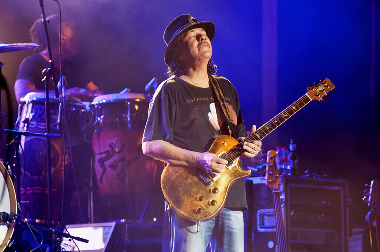 epa06944707 Mexican guitarist, composer and singer Carlos Santana performs on stage at Peraladas Festival, as part of his Divination Tour, in Castell Platja DÂ´Aro, Girona, northeastern Spain, 11 August 2018.  EPA