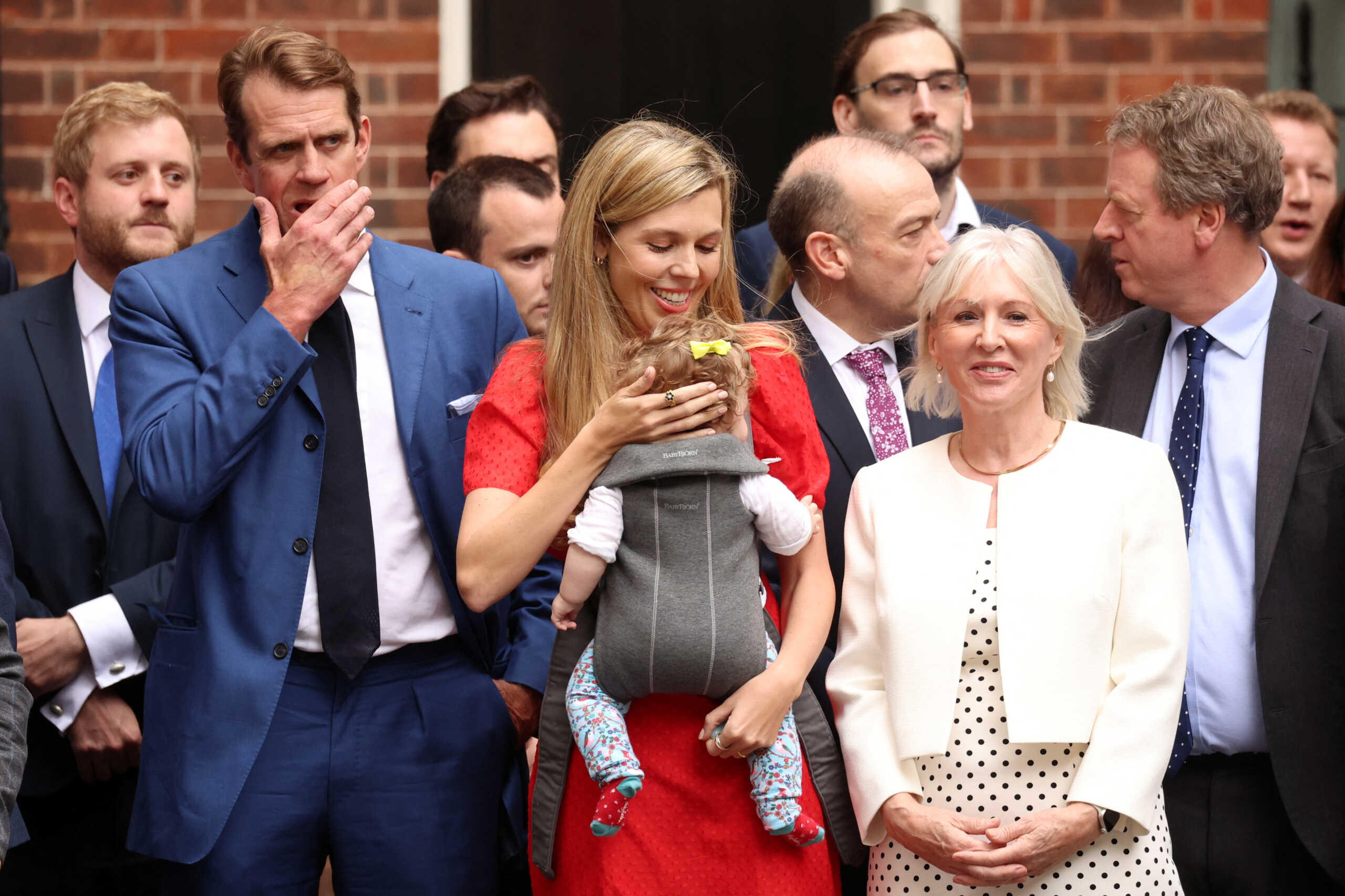 Carrie Johnson with her baby and British Culture Secretary Nadine Dorries stand as British Prime Minister Boris Johnson (not pictured) makes a statement at Downing Street in London, Britain, July 7, 2022. REUTERS