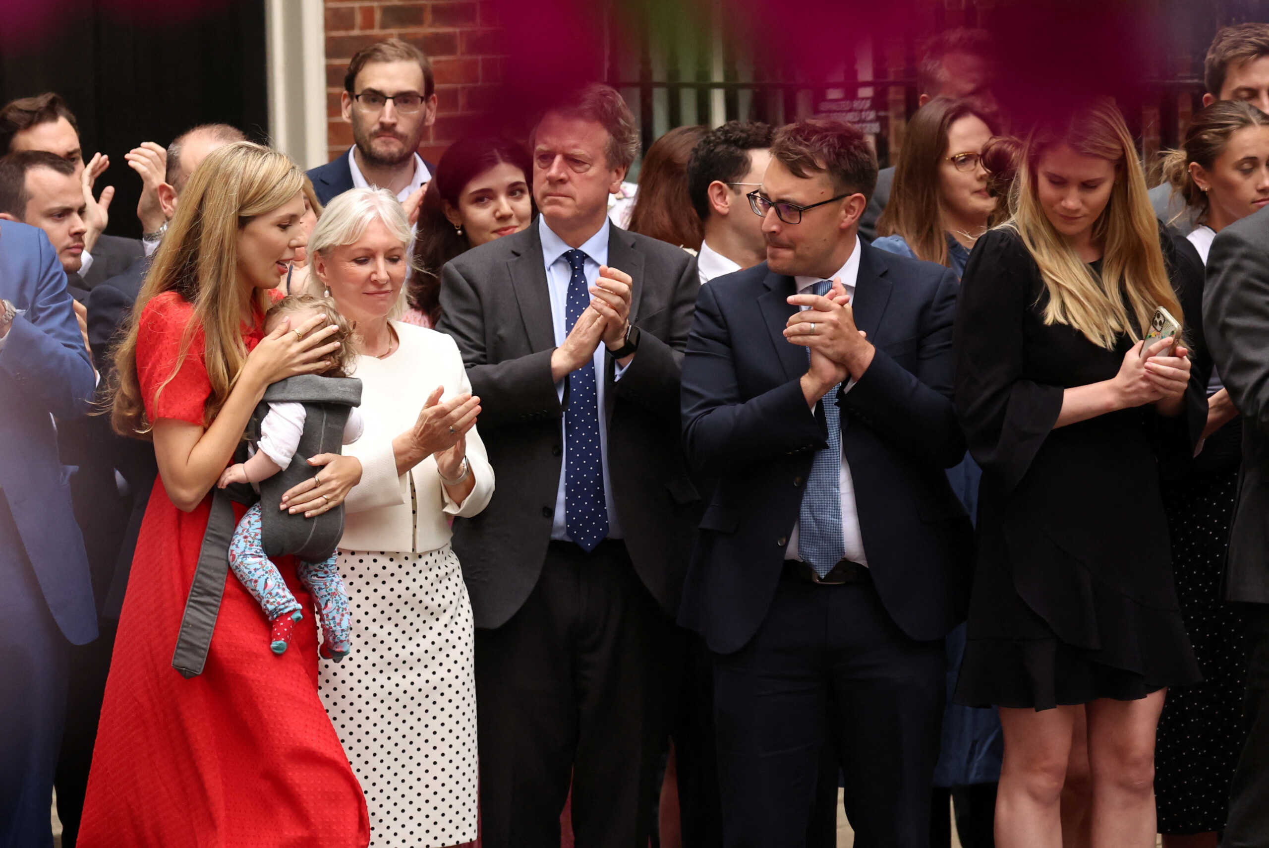 Carrie Johnson walks with her baby as British Prime Minister Boris Johnson (not pictured) makes a statement at Downing Street in London, Britain, July 7, 2022. REUTERS