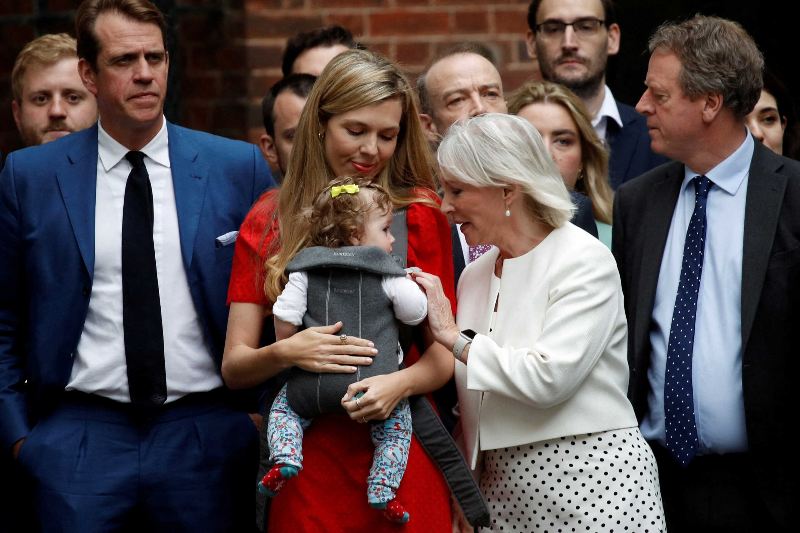 Carrie Johnson with her baby and British Culture Secretary Nadine Dorries attend British Prime Minister Boris Johnson making a statement at Downing Street in London, Britain, July 7, 2022. REUTERS