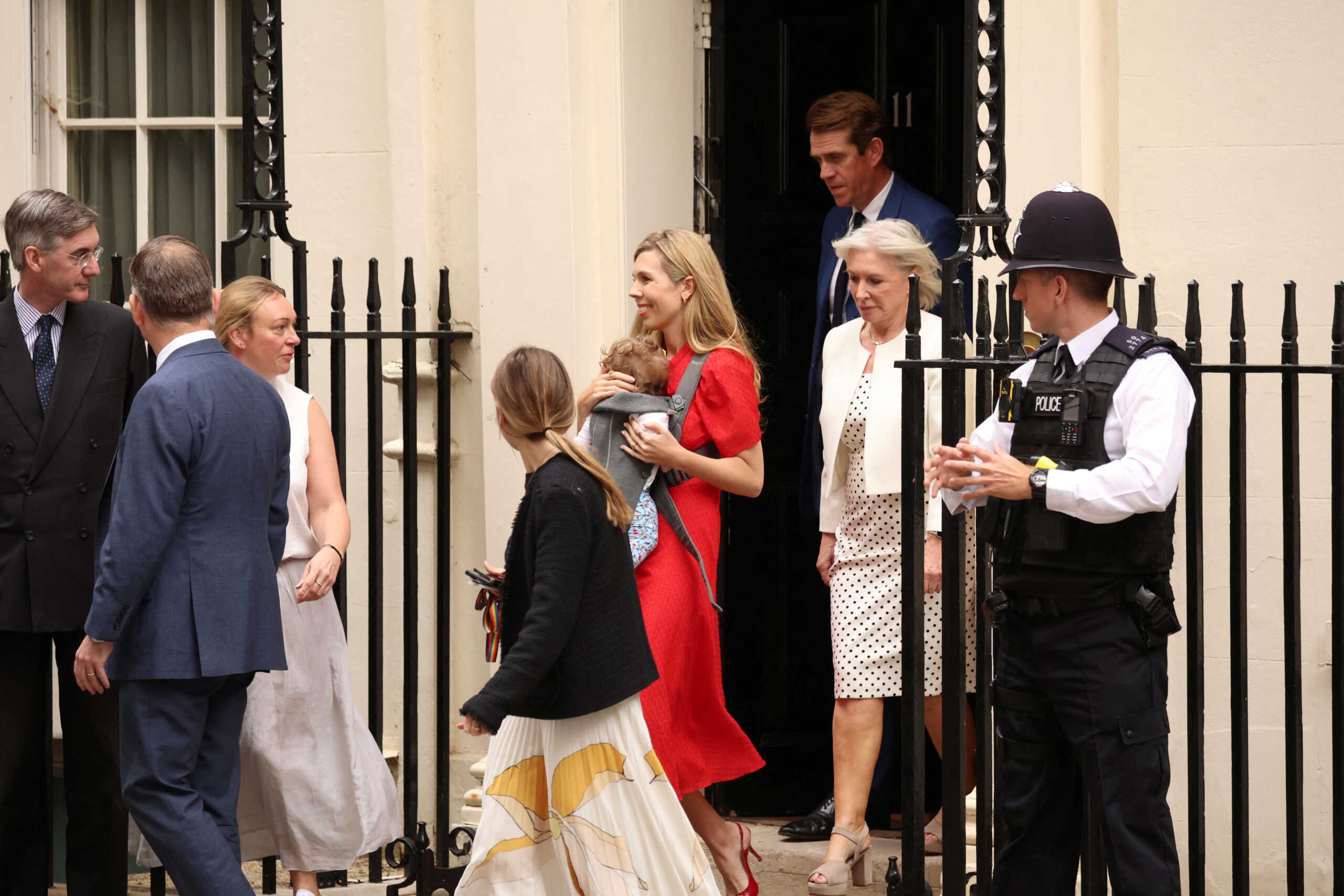 Carrie Johnson with her baby and British Culture Secretary Nadine Dorries walk as British Prime Minister Boris Johnson (not pictured) makes a statement at Downing Street in London, Britain, July 7, 2022. REUTERS