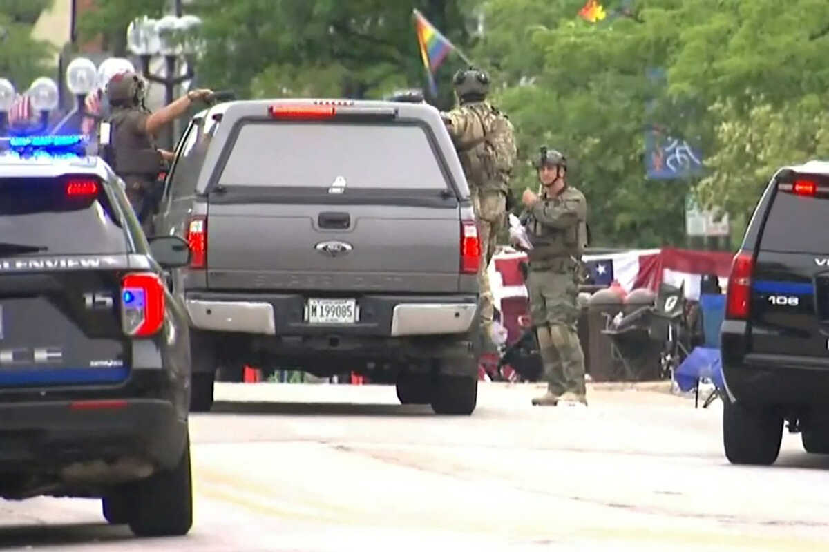 Police deploy after gunfire erupted at a Fourth of July parade route in the wealthy Chicago suburb of Highland Park, Illinois, U.S. July 4, 2022 in a still image from video. ABC affiliate WLS