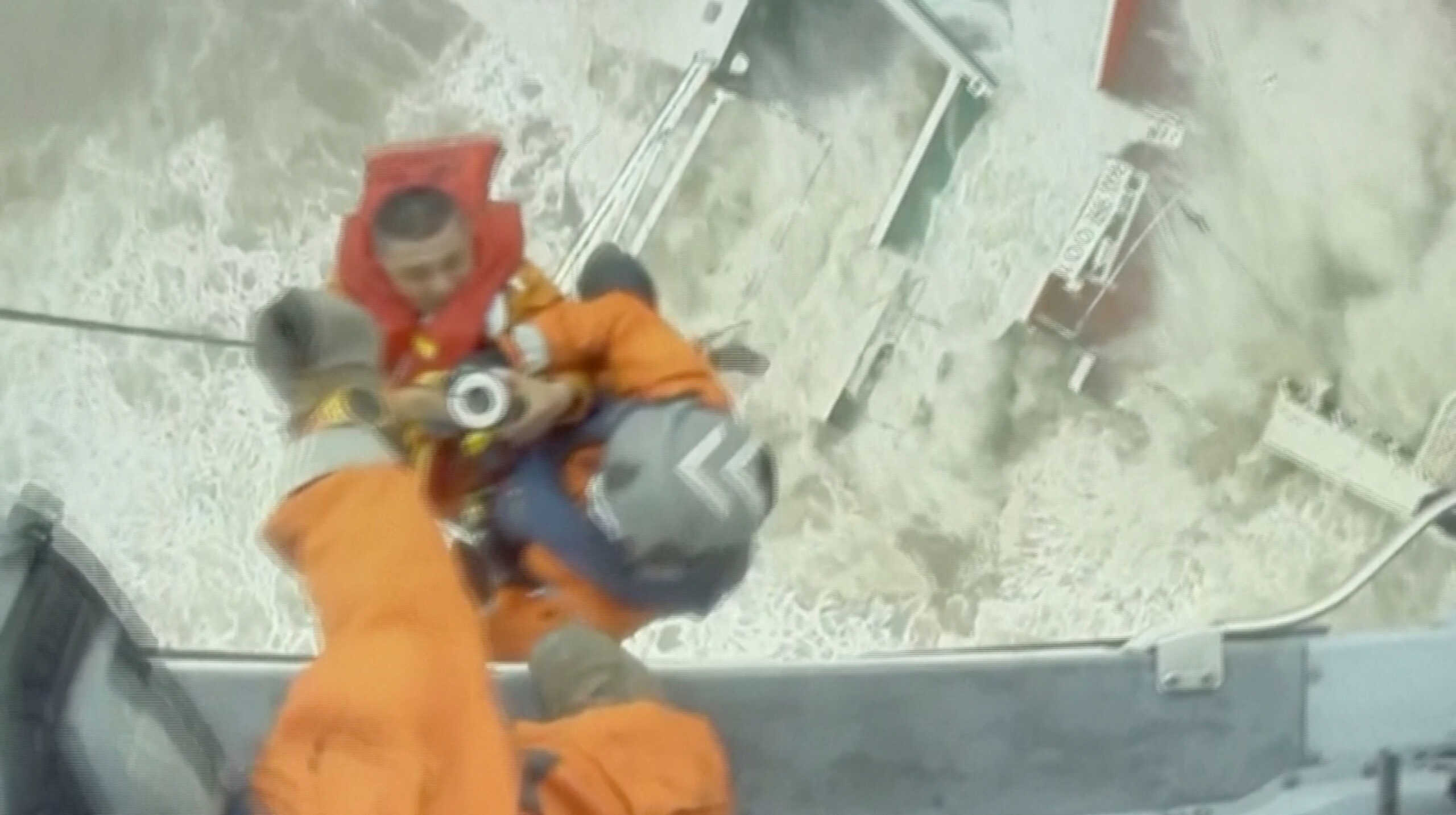 Rescuers lift a crew member of a sinking vessel into a helicopter, after it snapped in two as tropical storm Chaba passed through, according to authorities, in waters off Hong Kong, China in this screen grab taken from a video July 2, 2022. Hong Kong Government Flying Service
