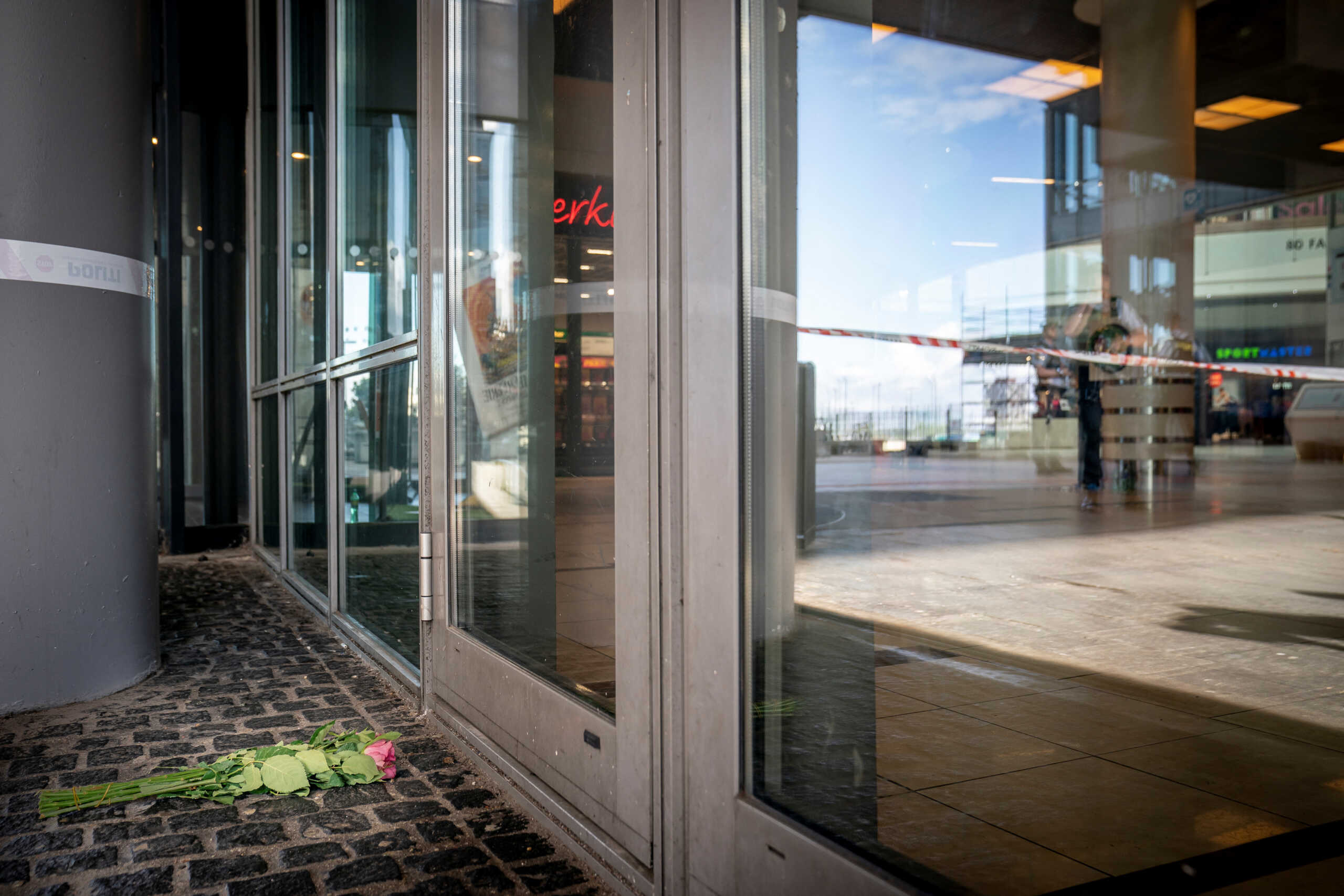 Flowers are placed outside the closed Field's shopping centre, a day after a shooting occurred at the mall, in Copenhagen, Denmark July 4, 2022. Ritzau Scanpix
