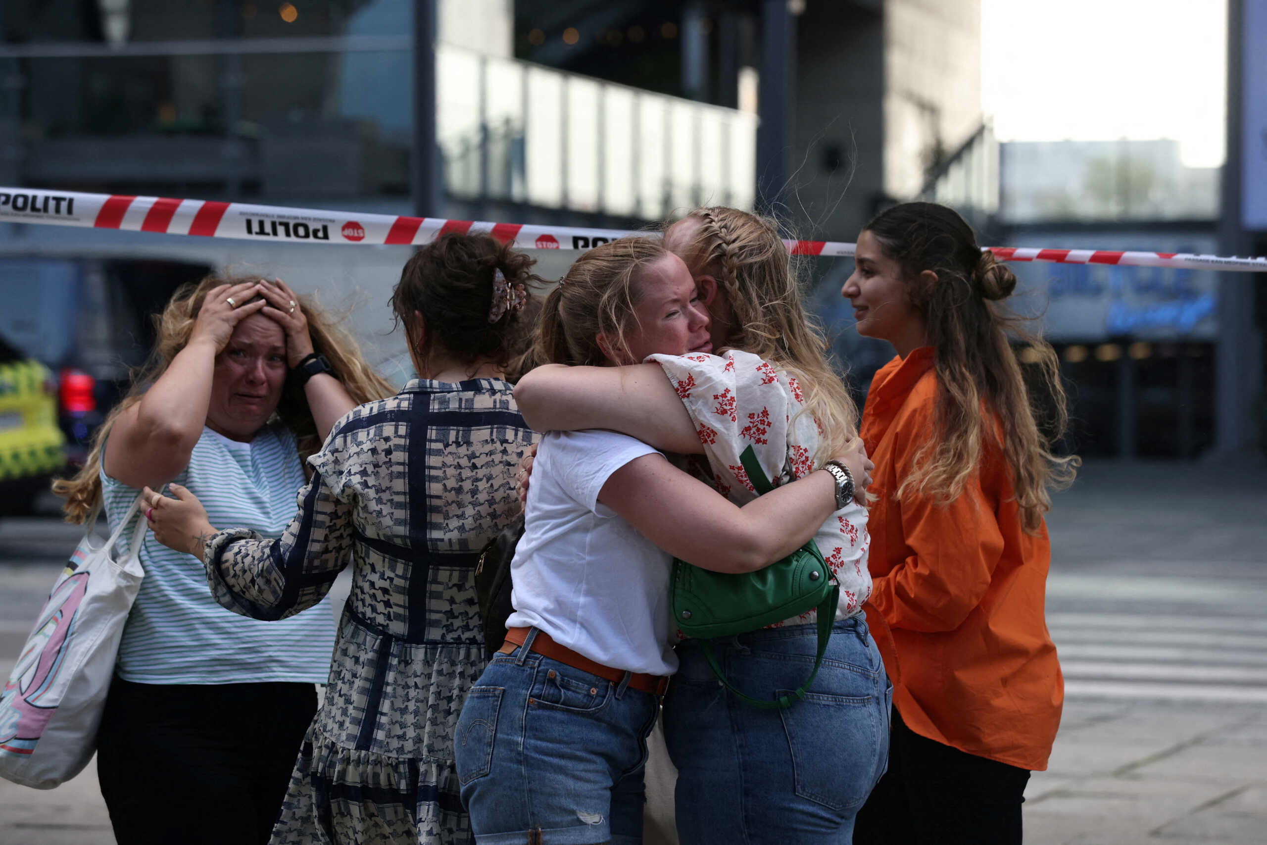 People embrace outside Field's shopping centre, after Danish police said they received reports of a shooting at the site, in Copenhagen, Denmark, July 3, 2022. Ritzau Scanpix