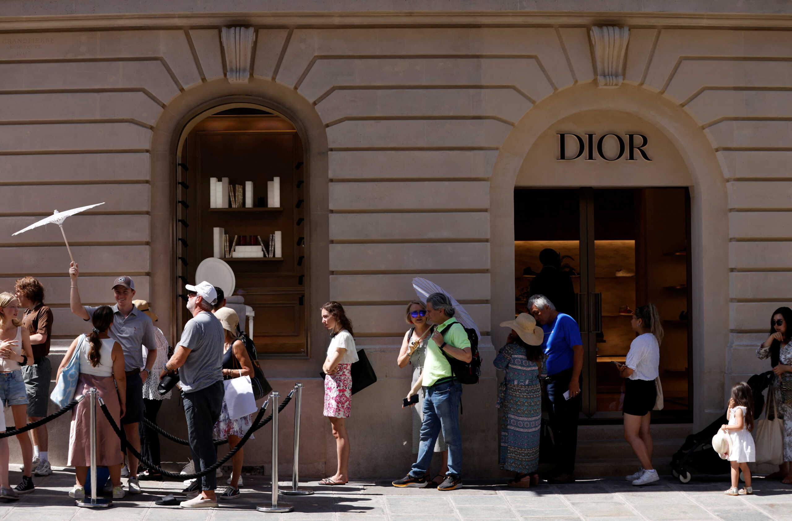 People queue to enter La Galerie Dior, the museum of fashion house Dior, in Paris, France, July 13, 2022. REUTERS