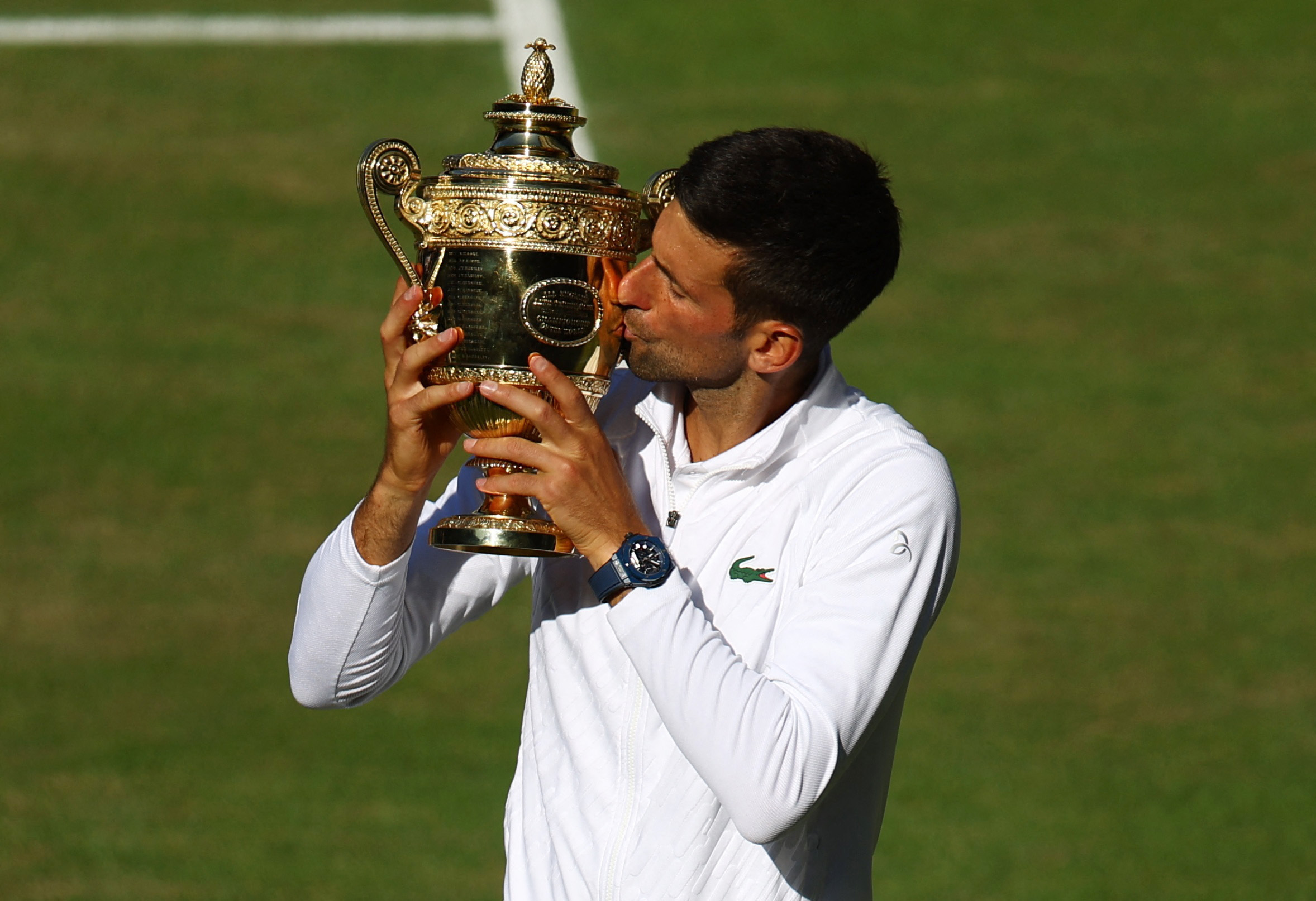 Tennis - Wimbledon - All England Lawn Tennis and Croquet Club, London, Britain - July 10, 2022 Serbia's Novak Djokovic celebrates with the trophy after winning the men's singles final against Australia's Nick Kyrgios REUTERS