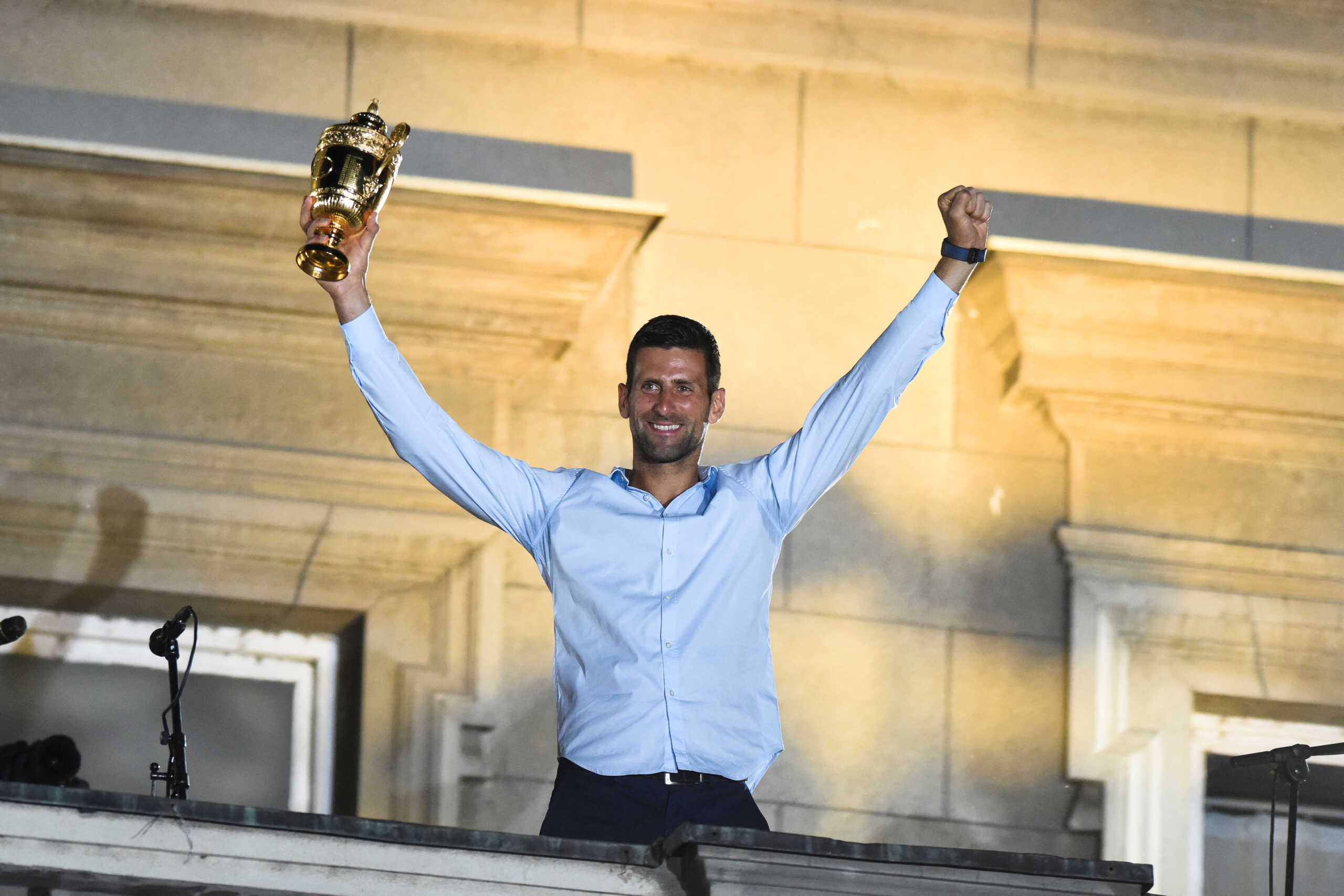 Serbian tennis player Novak Djokovic holds up the winner's trophy during a welcoming ceremony in front of the city hall in Belgrade, in Serbia, July 11, 2022. REUTERS
